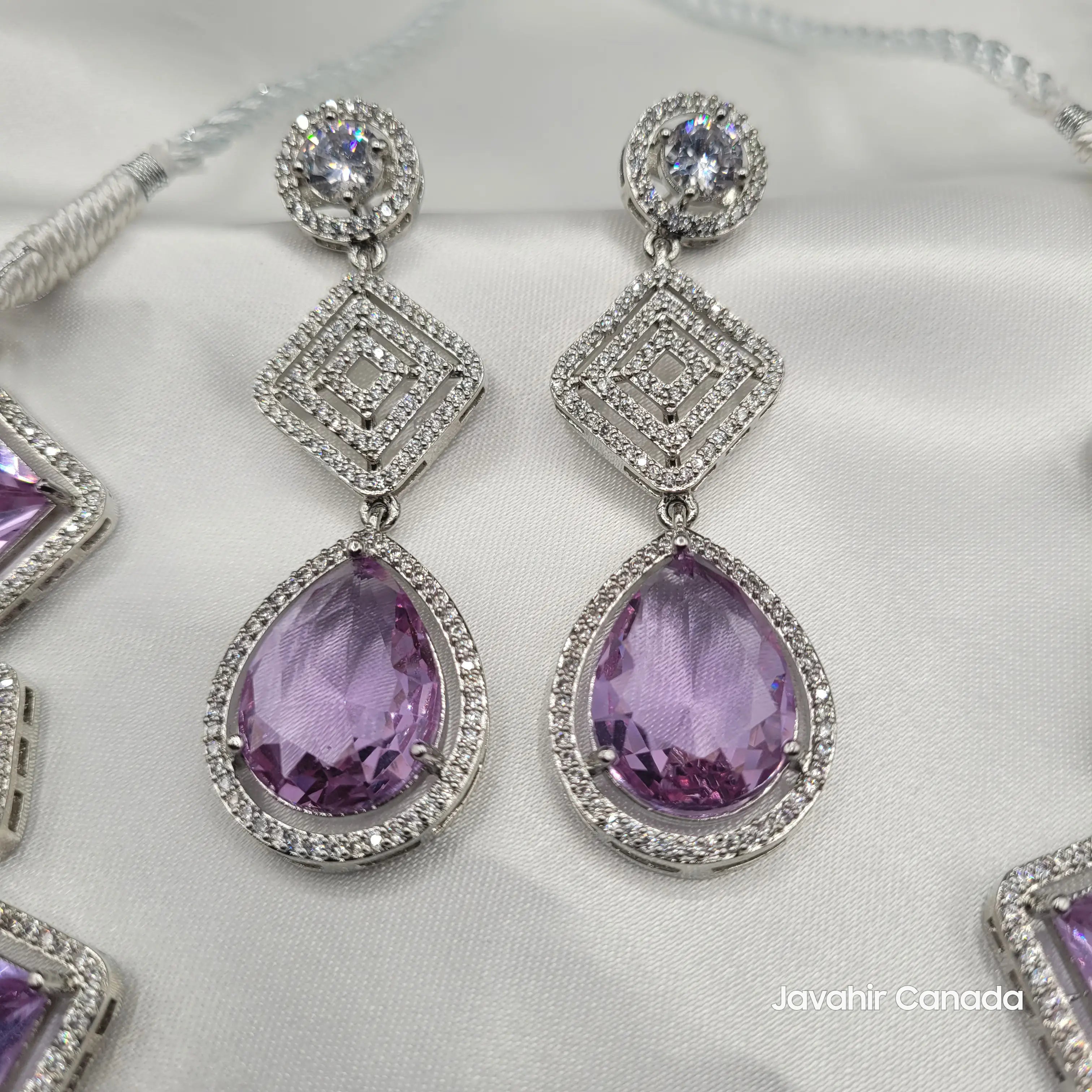 JV149 lilac purple teardrop earrings with sparkling zircon accents on satin.