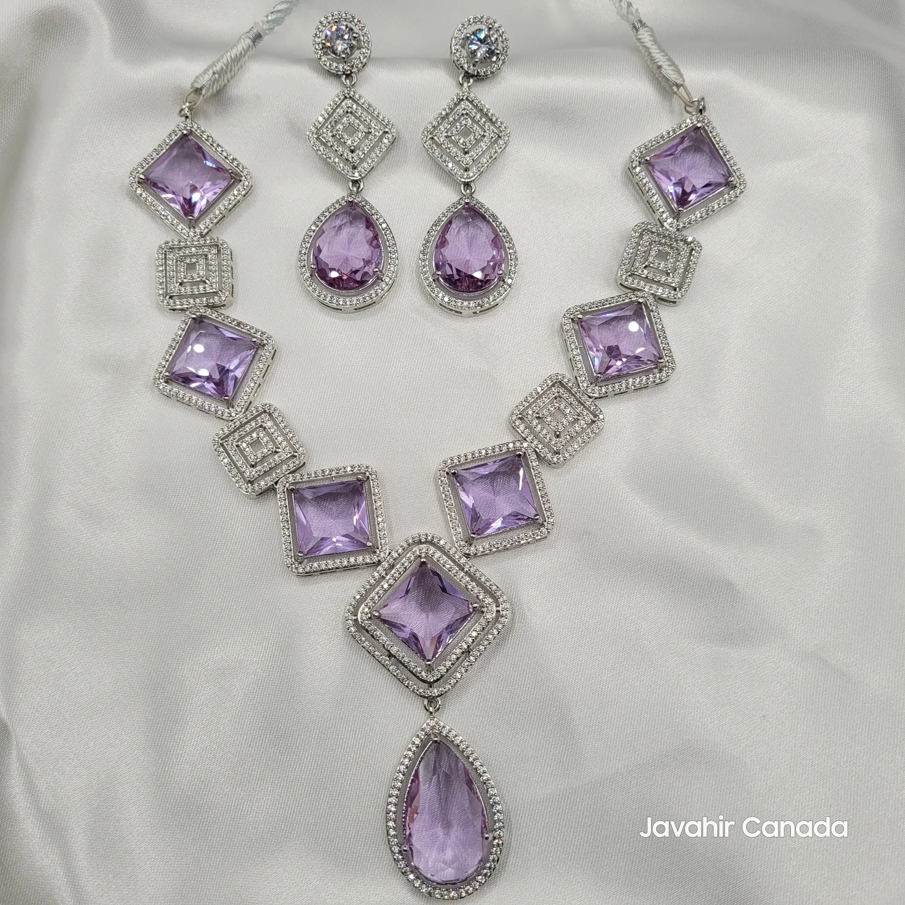 Full JV149 lilac gemstone necklace and matching earrings displayed on white satin.