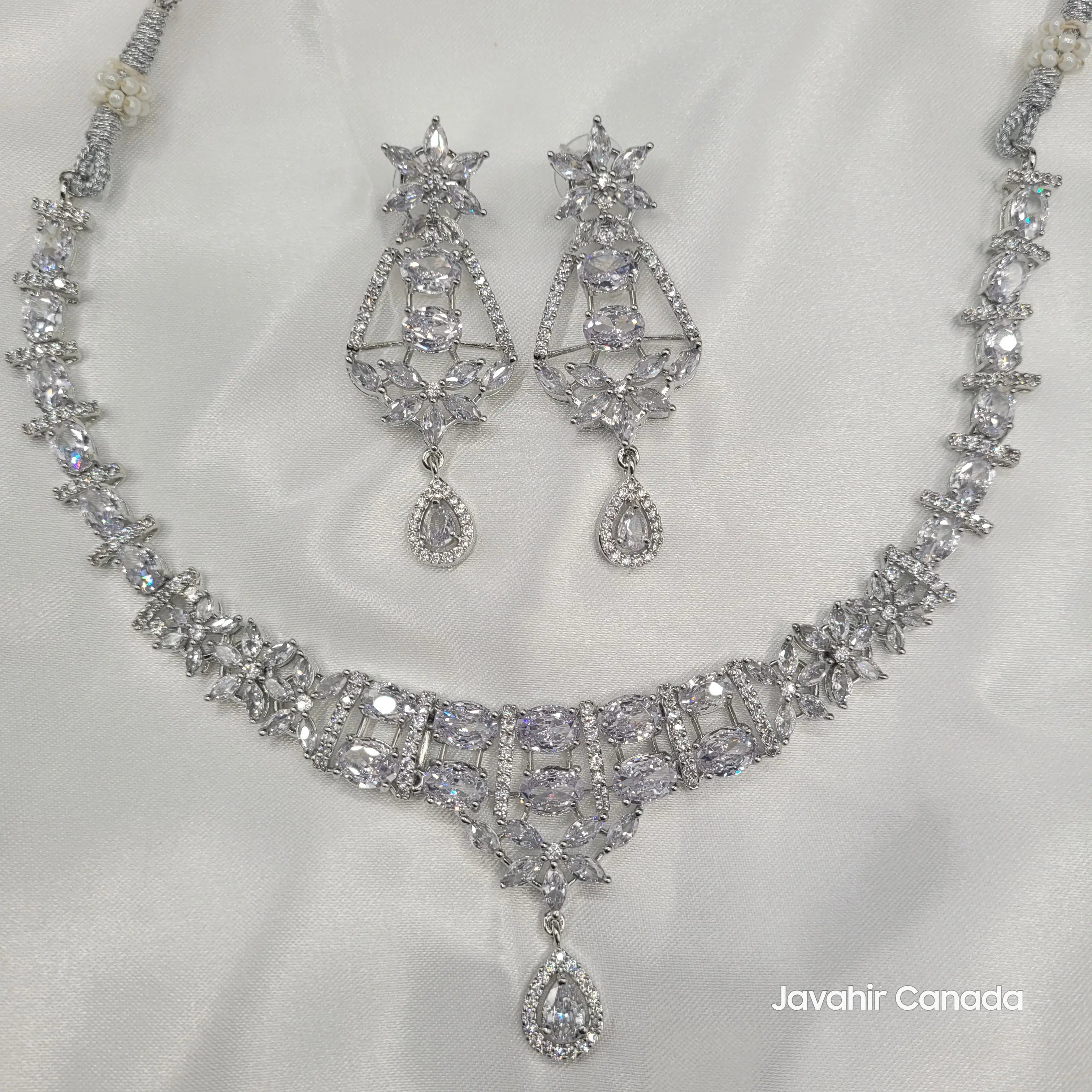 Full view of JV150 necklace set in silver variant with floral design and matching earrings.