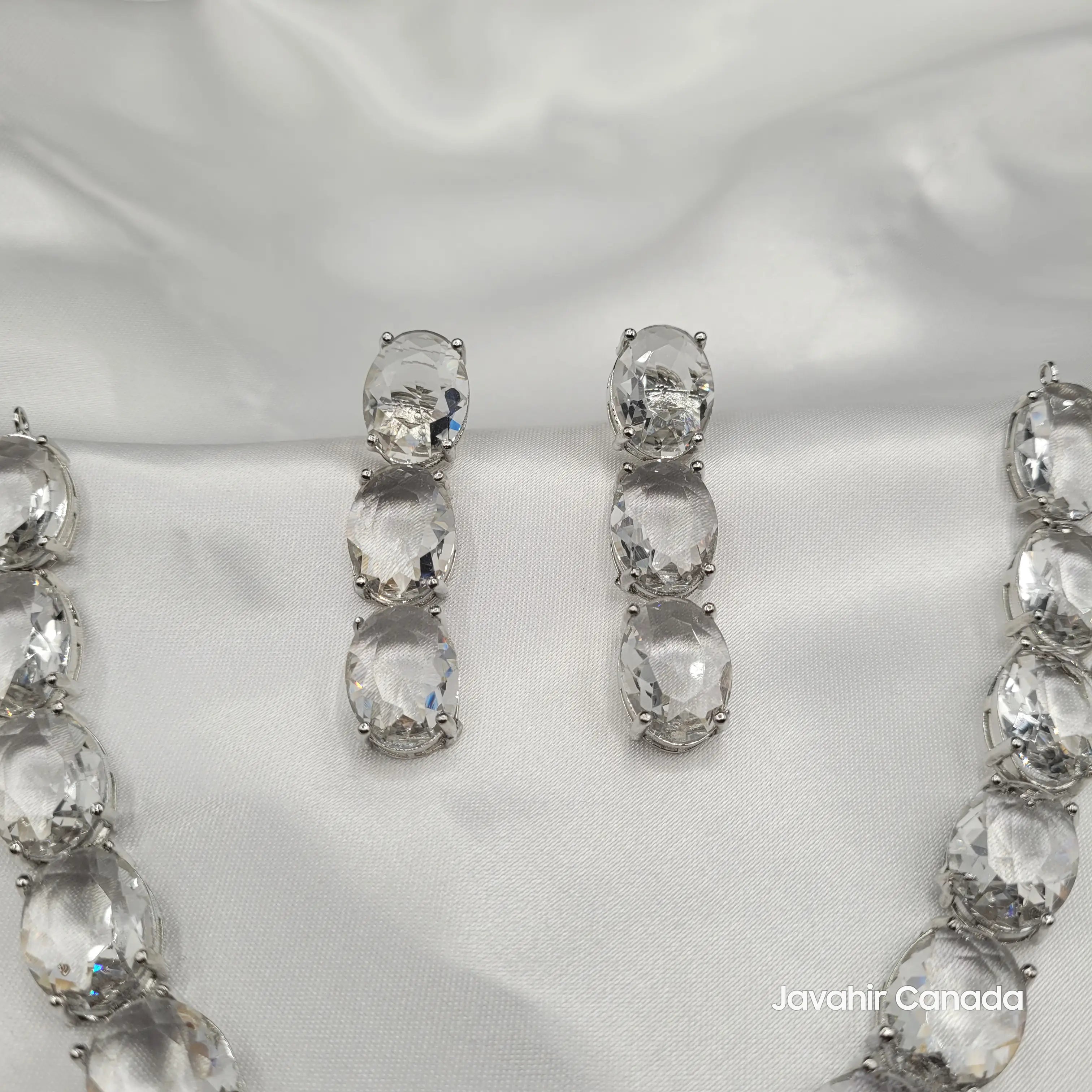 Angled image of JV151 clear CZ necklace with polished silver setting