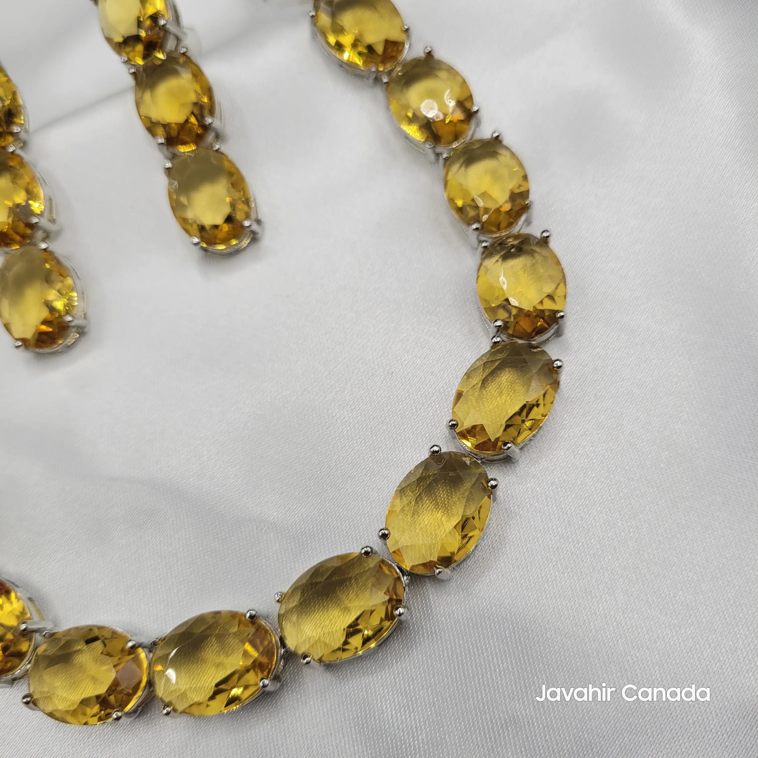 Close-up of citrine gemstone necklace curve with vibrant golden stones