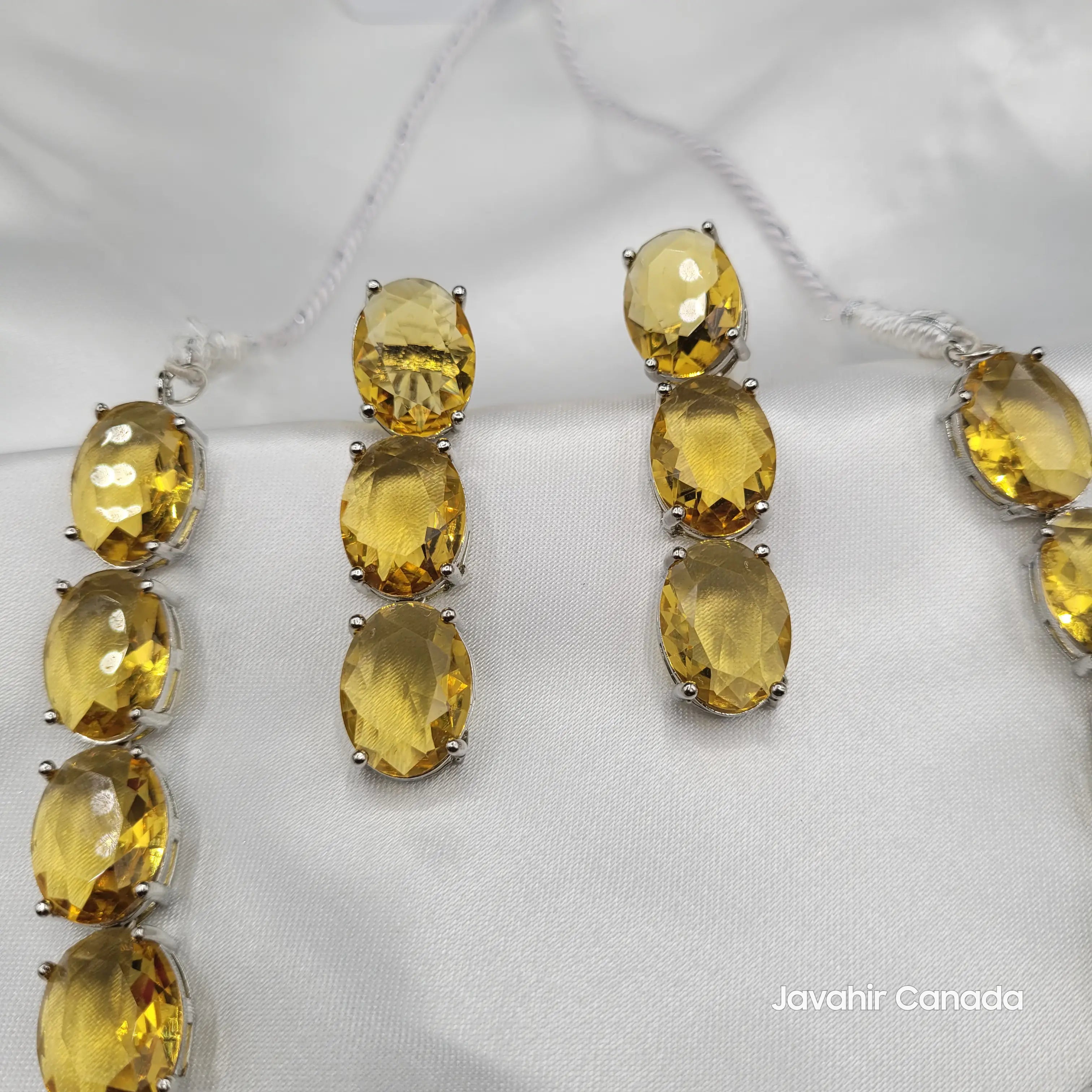 Earring close-up from JV151 citrine variant showing oval-cut yellow stones