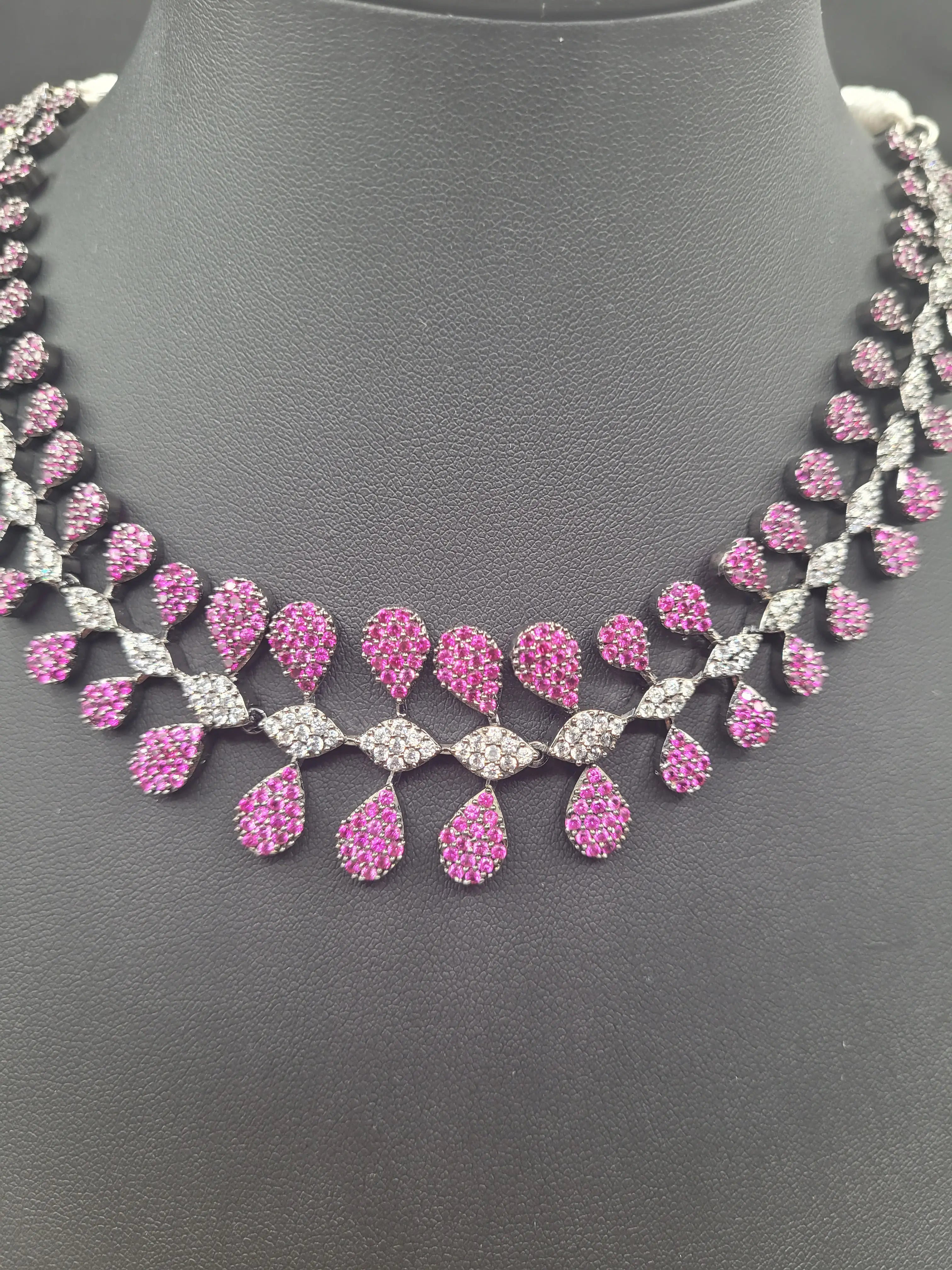 Detailed front view of pink variant JV152 necklace with alternating pink and white teardrop CZs set in a silver tone.
