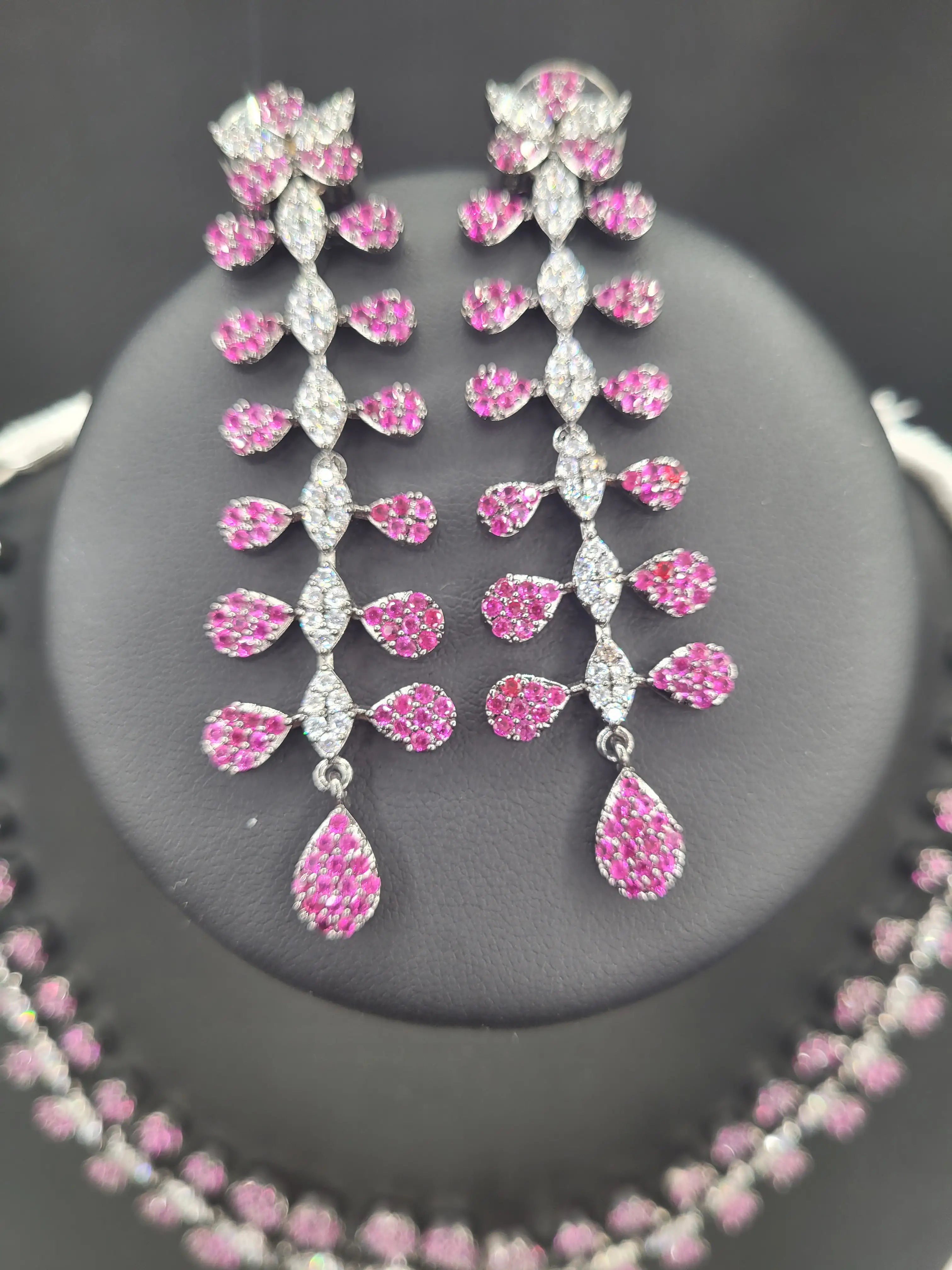 Zoomed-in image of pink zircon earrings from the JV152 set, showing intricate teardrop CZ detailing in a cascading floral design.