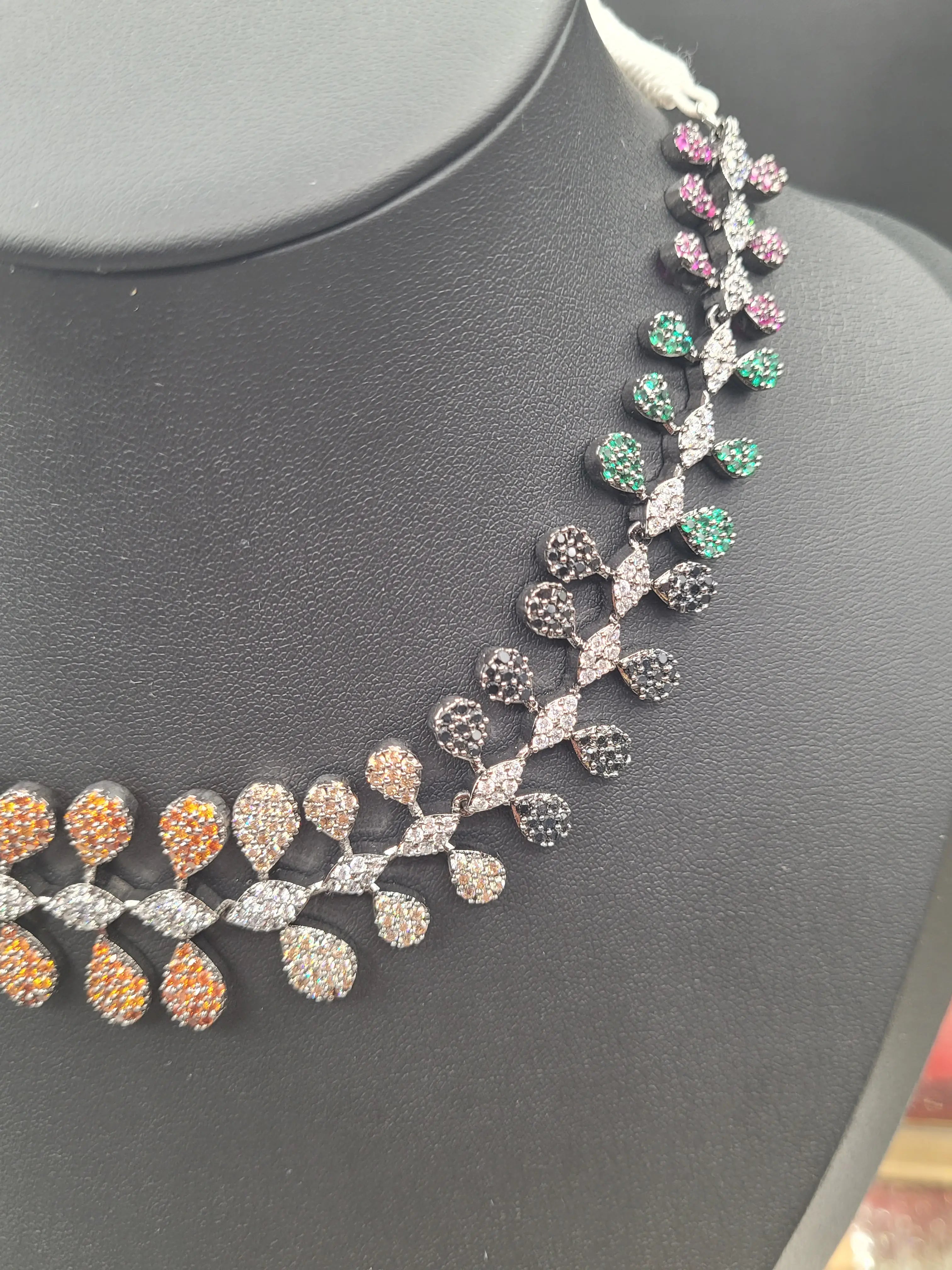 Side angle of the JV152 necklace showing multicolour teardrop-shaped American diamond clusters arranged symmetrically.