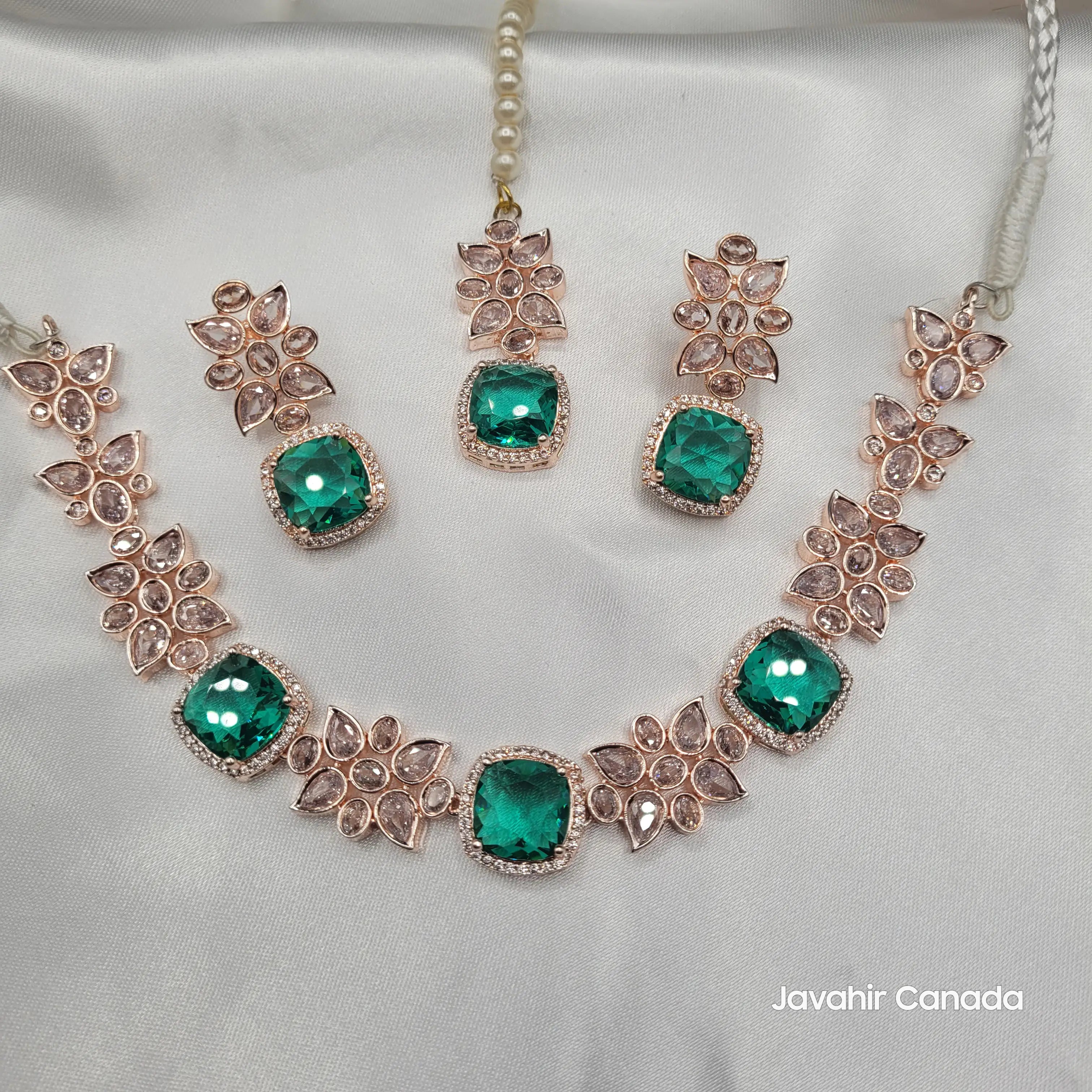 Full emerald variant of the JV153 necklace set with matching drop earrings and pearl string tikka, featuring floral American diamond detailing.