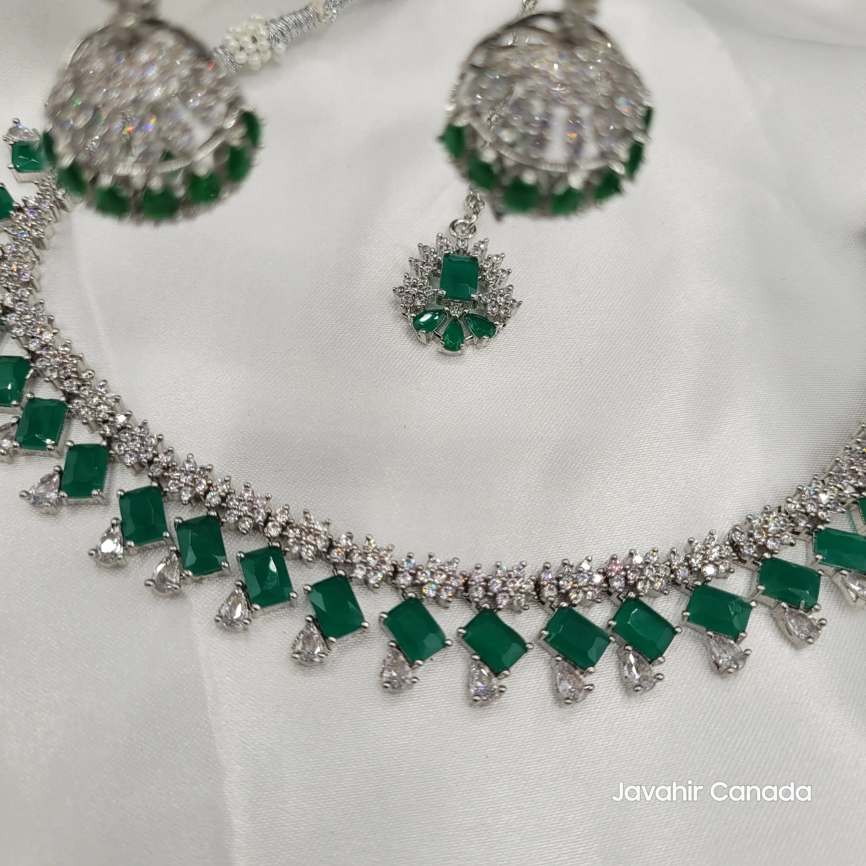Angled shot of JV19 necklace set with jhumkas and matching tikka, emphasizing the sparkle.