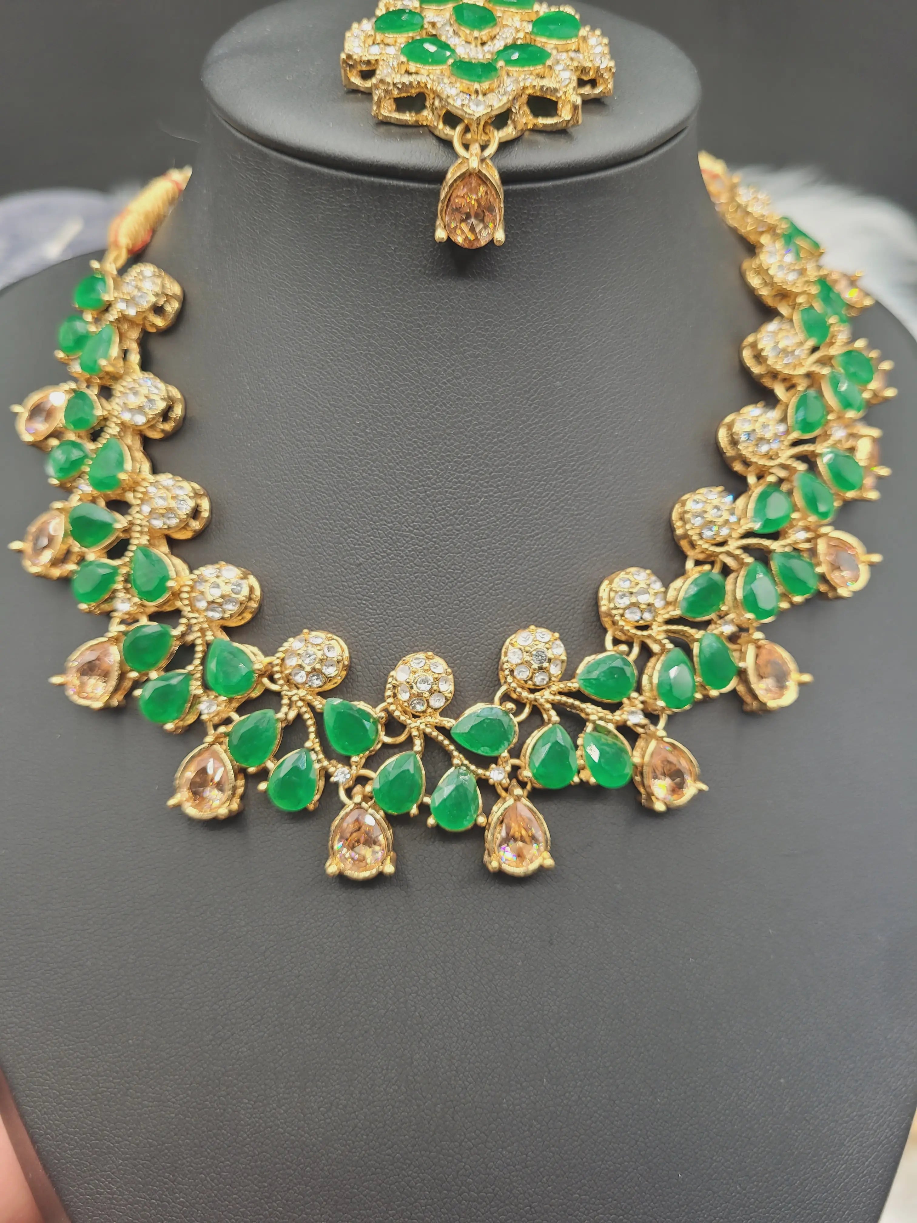 JV20 mint green necklace set with earrings and tikka displayed on black jewelry stand