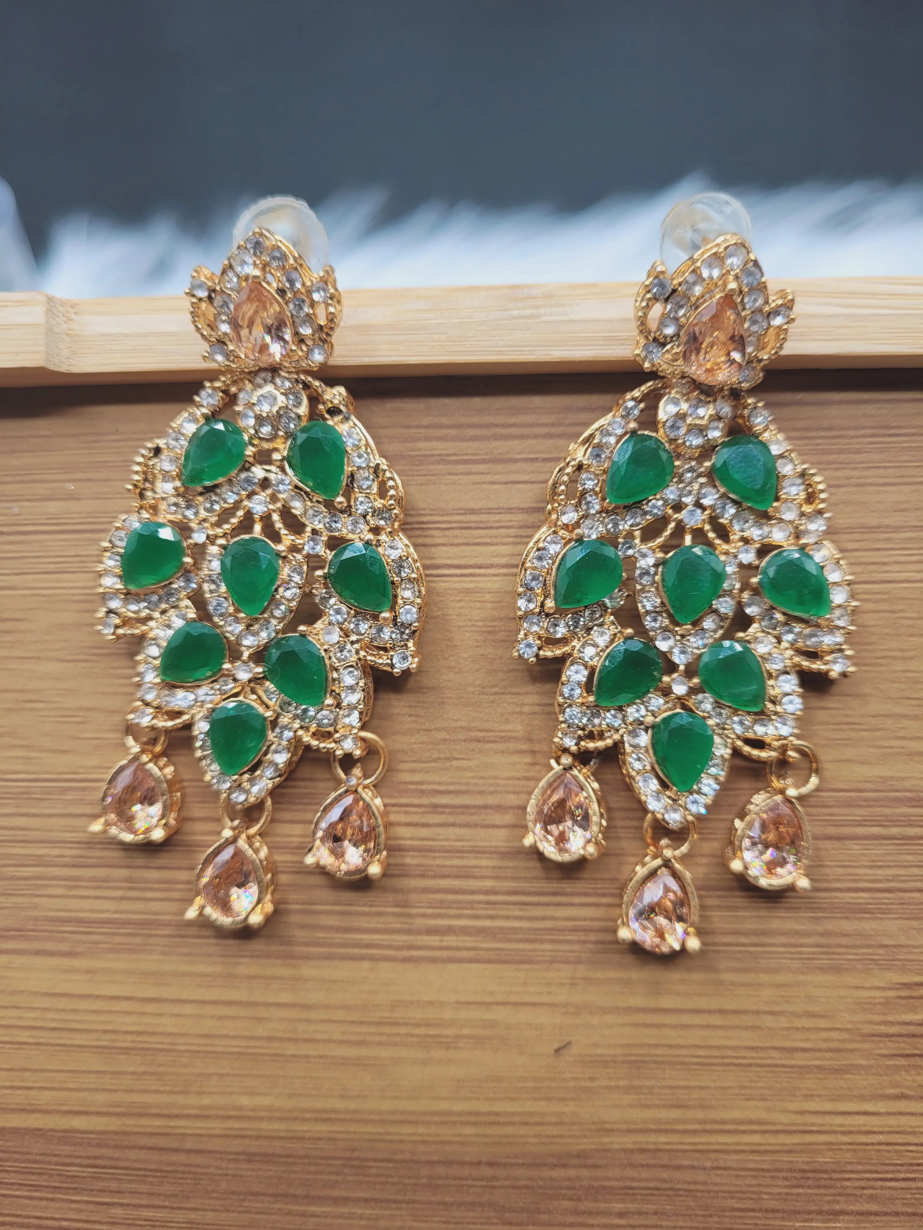 JV20 emerald green earrings featuring pear-cut stones and CZ detailing
