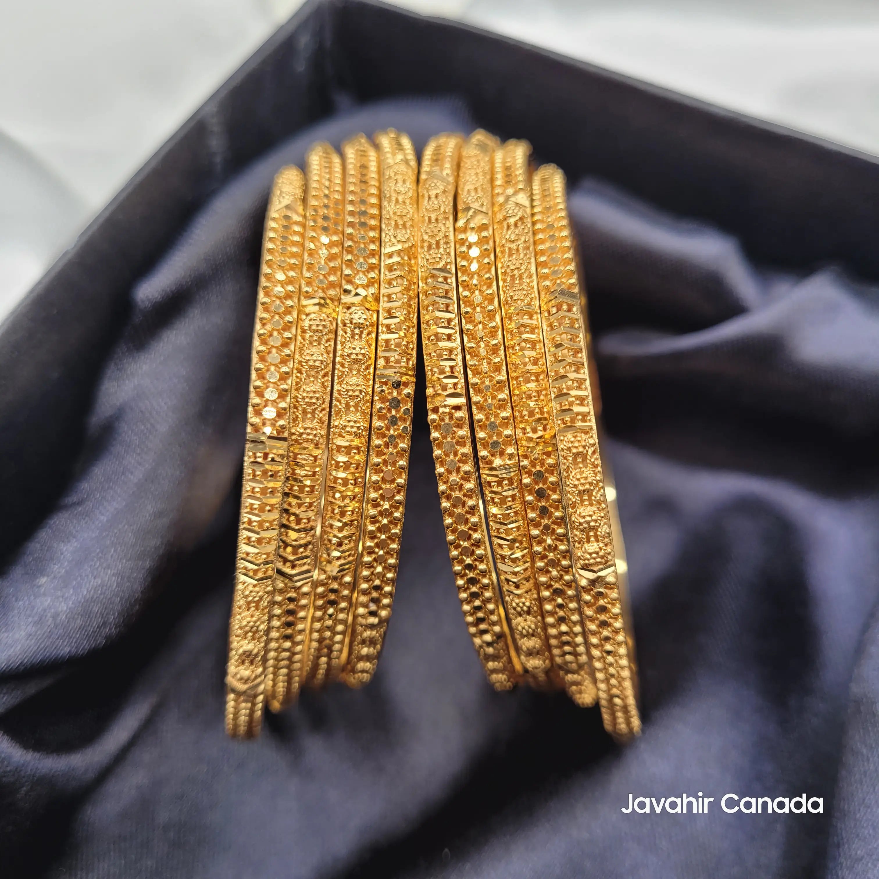 JV3032 gold plated bangles set of 8 displayed in velvet box