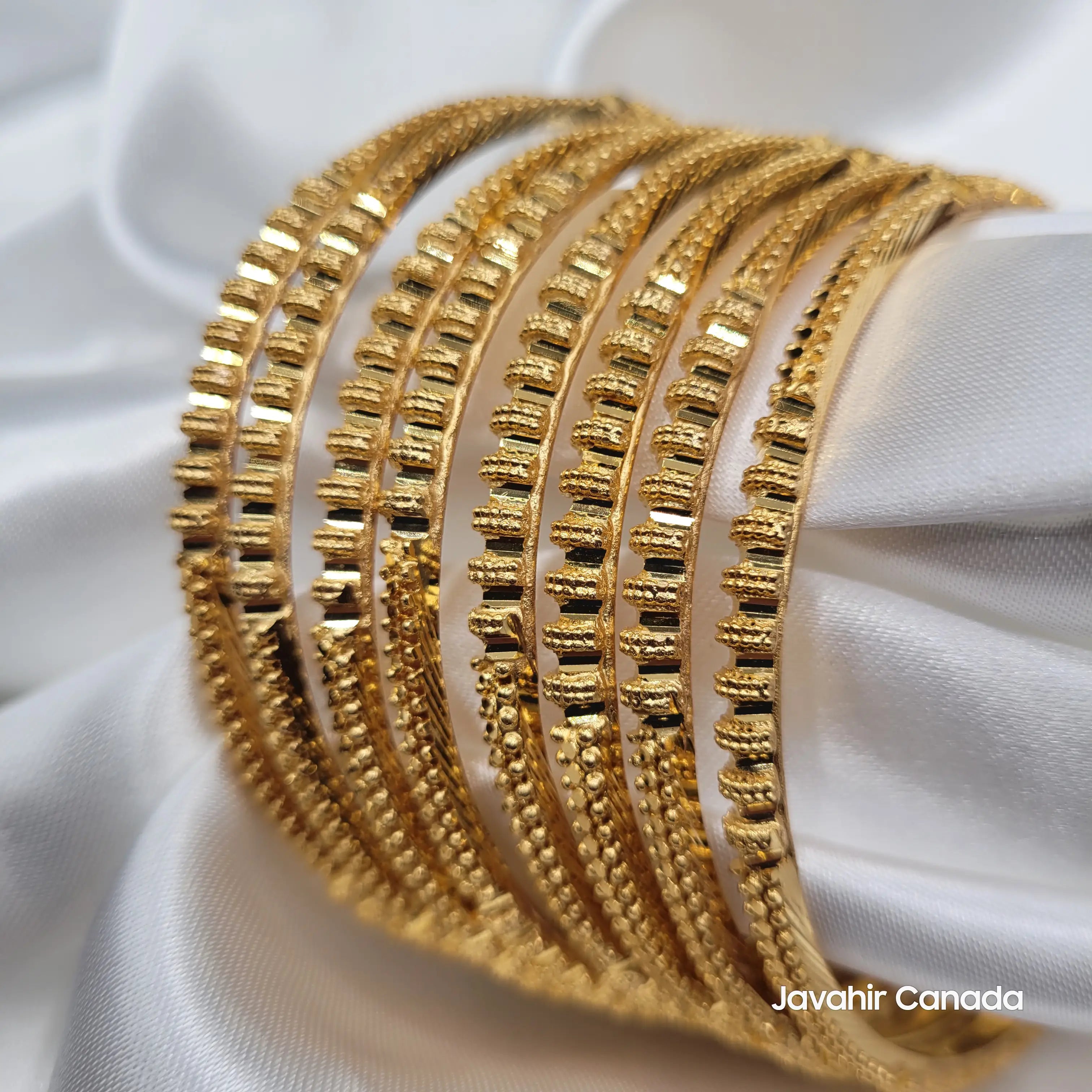 Detailed view of 22K gold plated Pakistani bangles with raised bar pattern