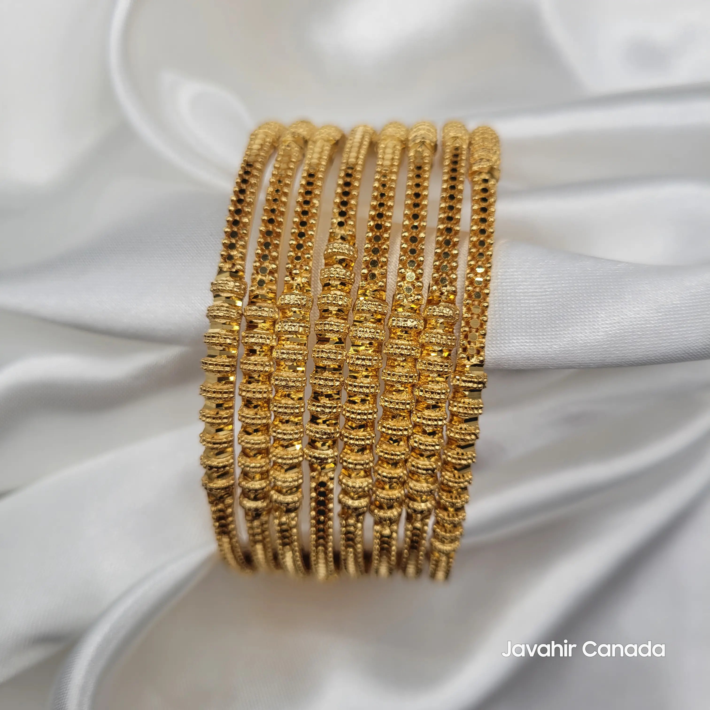 Set of 8 JV3033 bangles featuring symmetrical textured gold accents