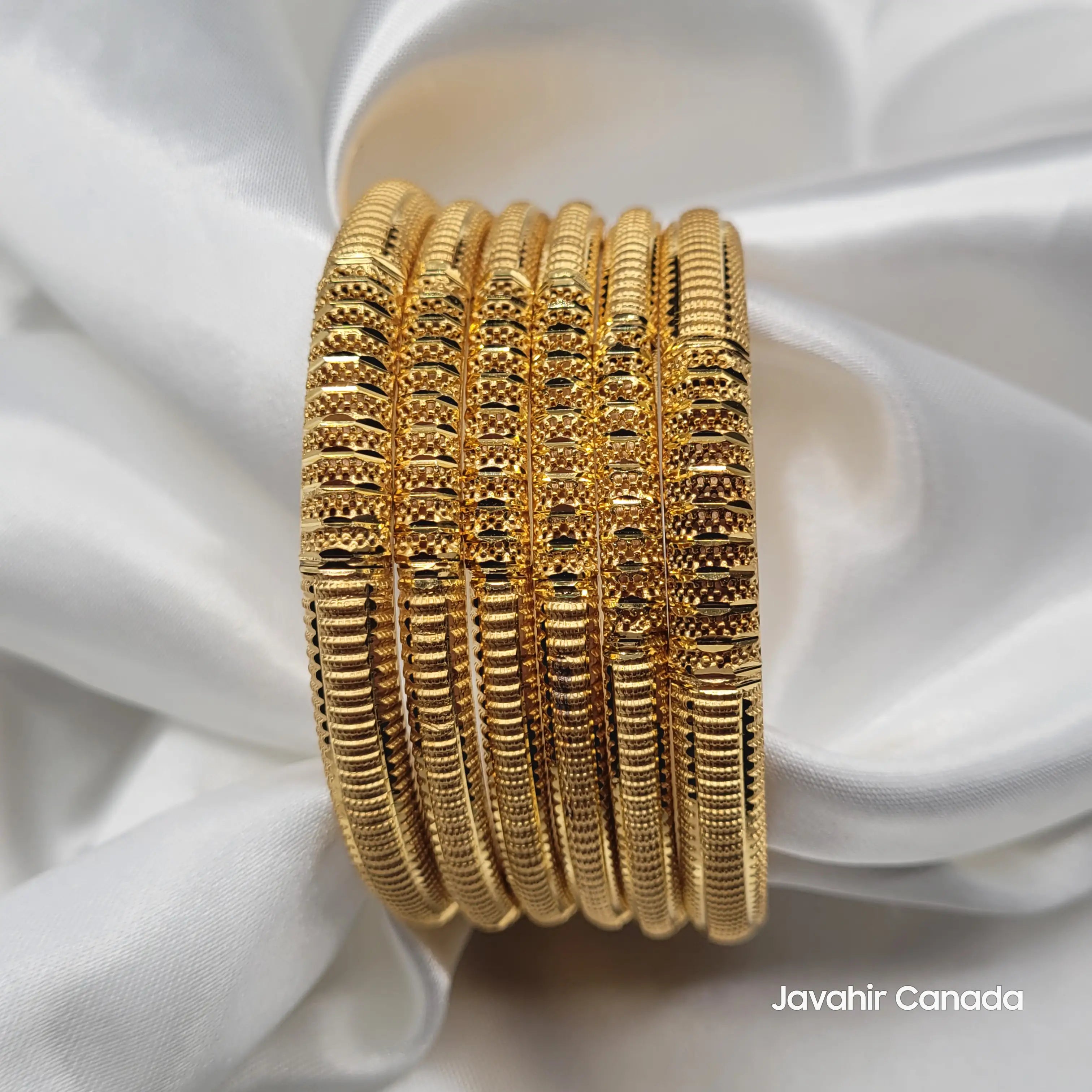 Stacked view of JV3038 engraved bangles on white satin