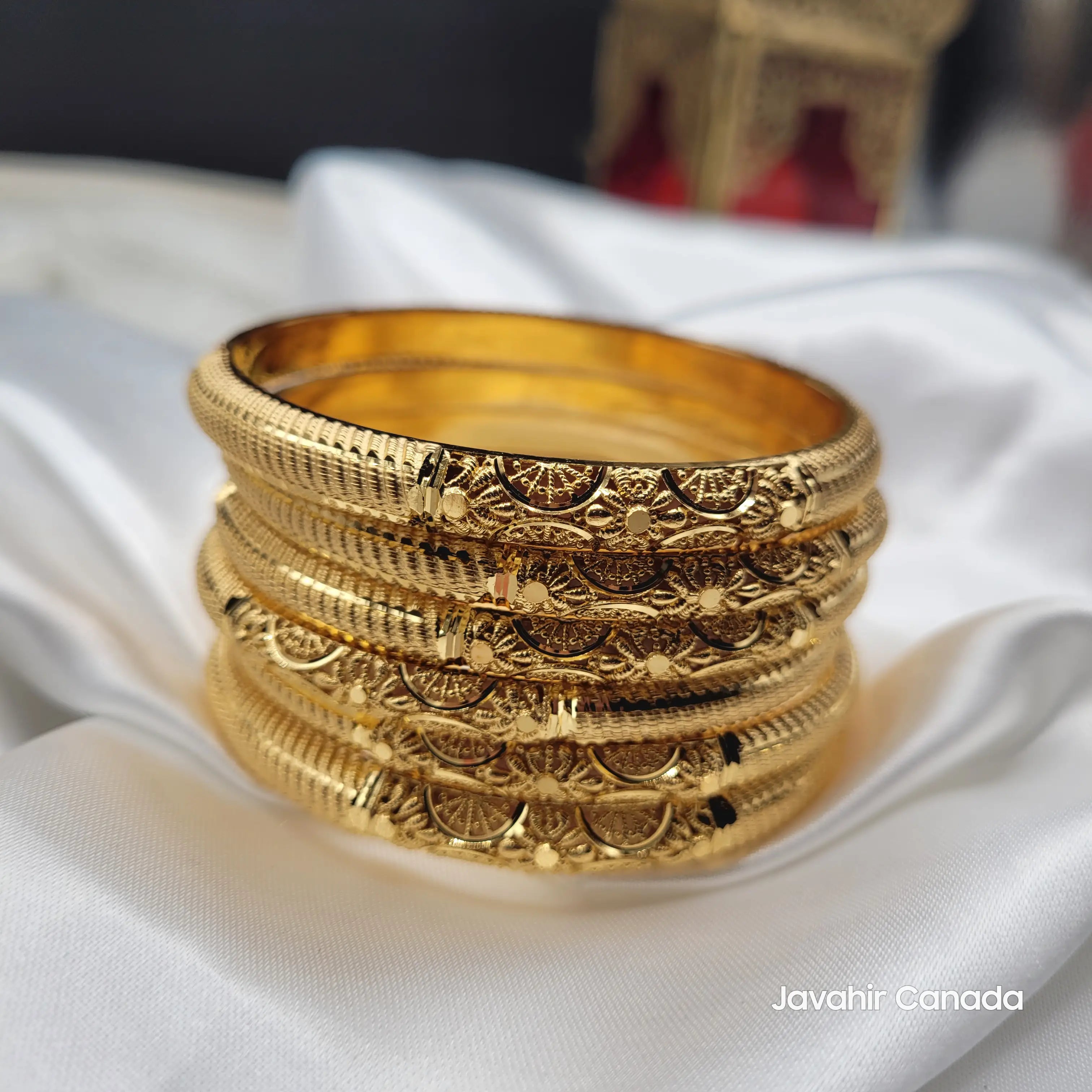 JV3039 gold plated crescent filigree bangles stacked on white satin – set of 6