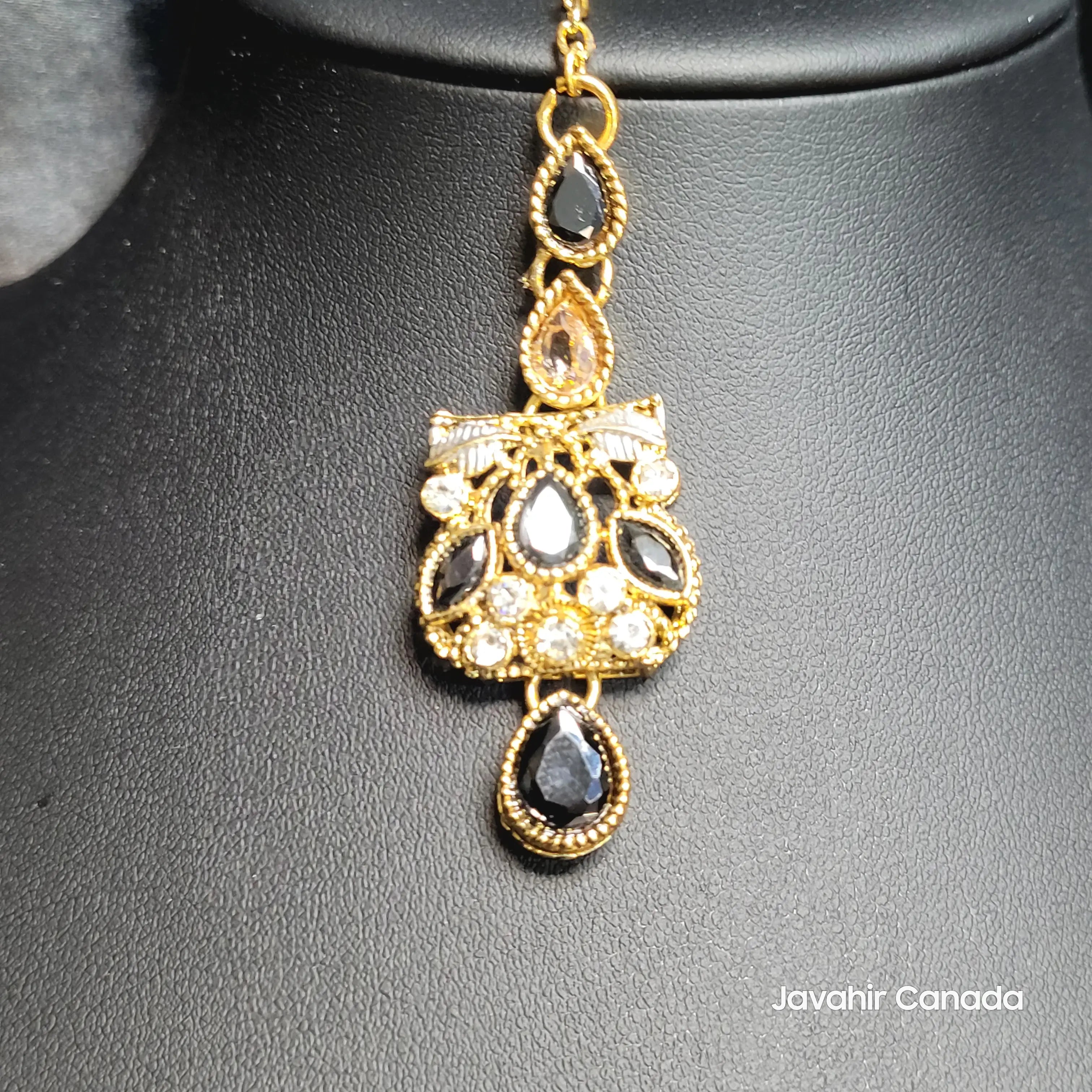 Bold traditional Teeka featuring black and champagne stones