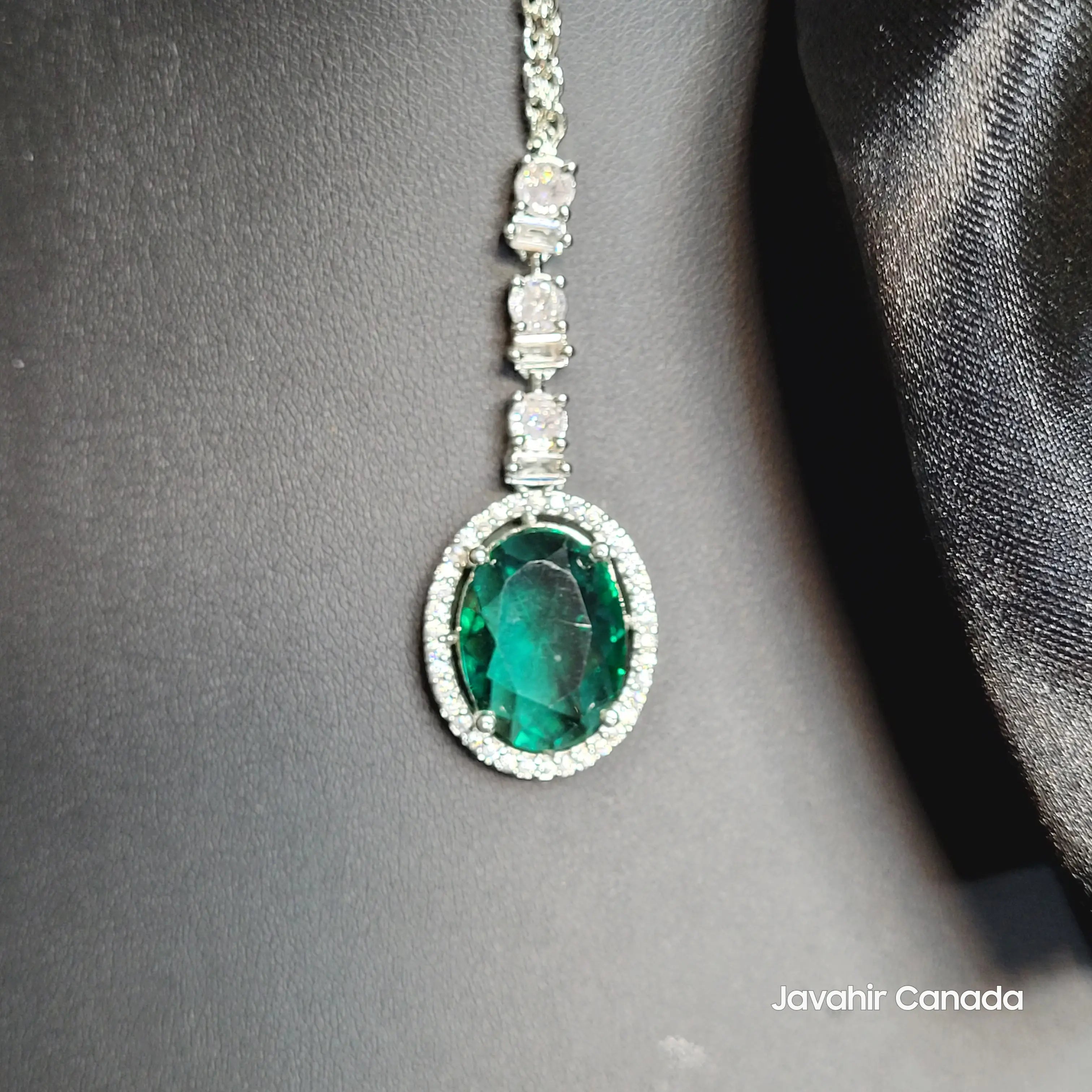 JV5213 Teeka with emerald green oval stone and diamond halo