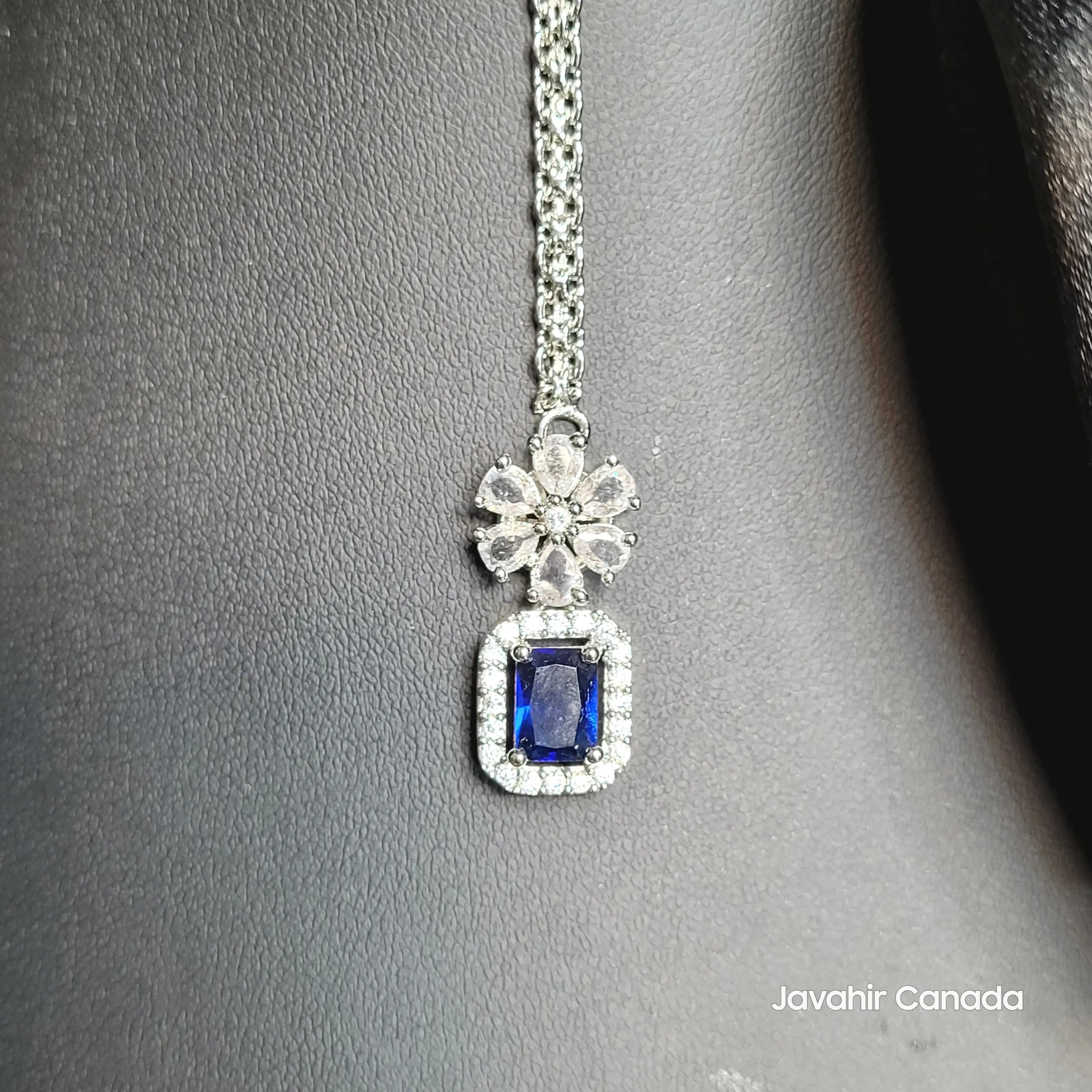 Close-up of sapphire tikka with American diamonds