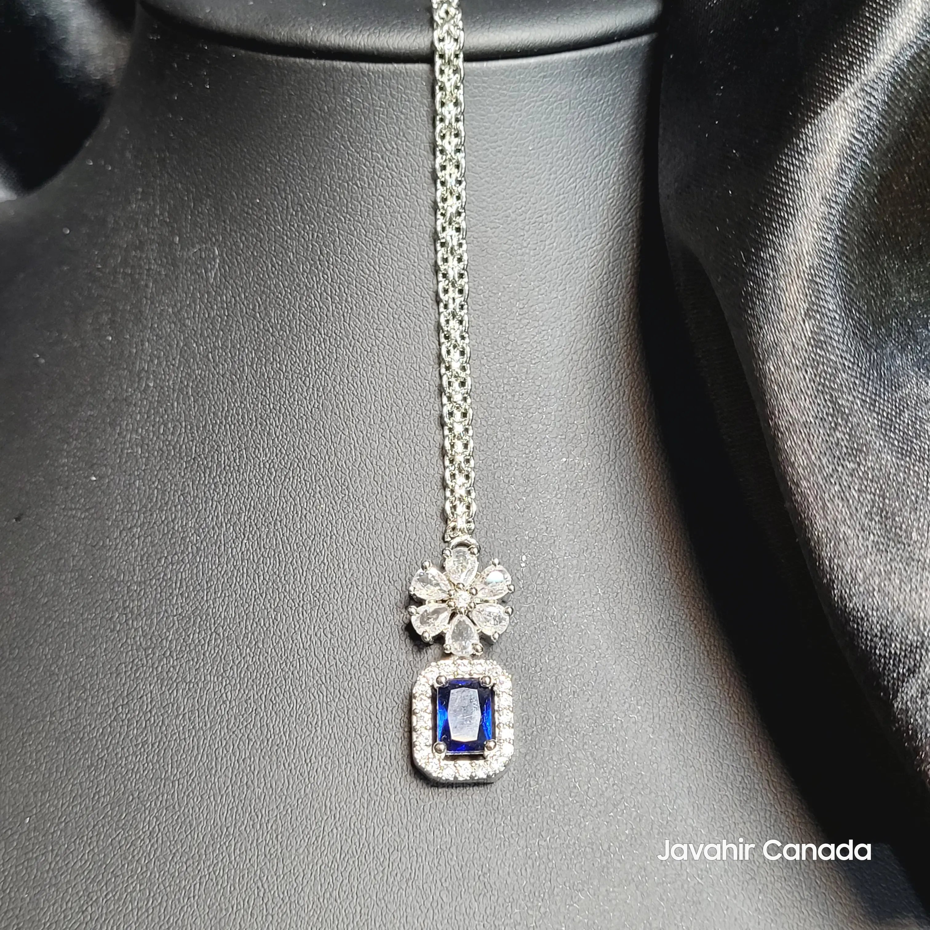 JV5214 Teeka with sapphire blue center and diamond halo
