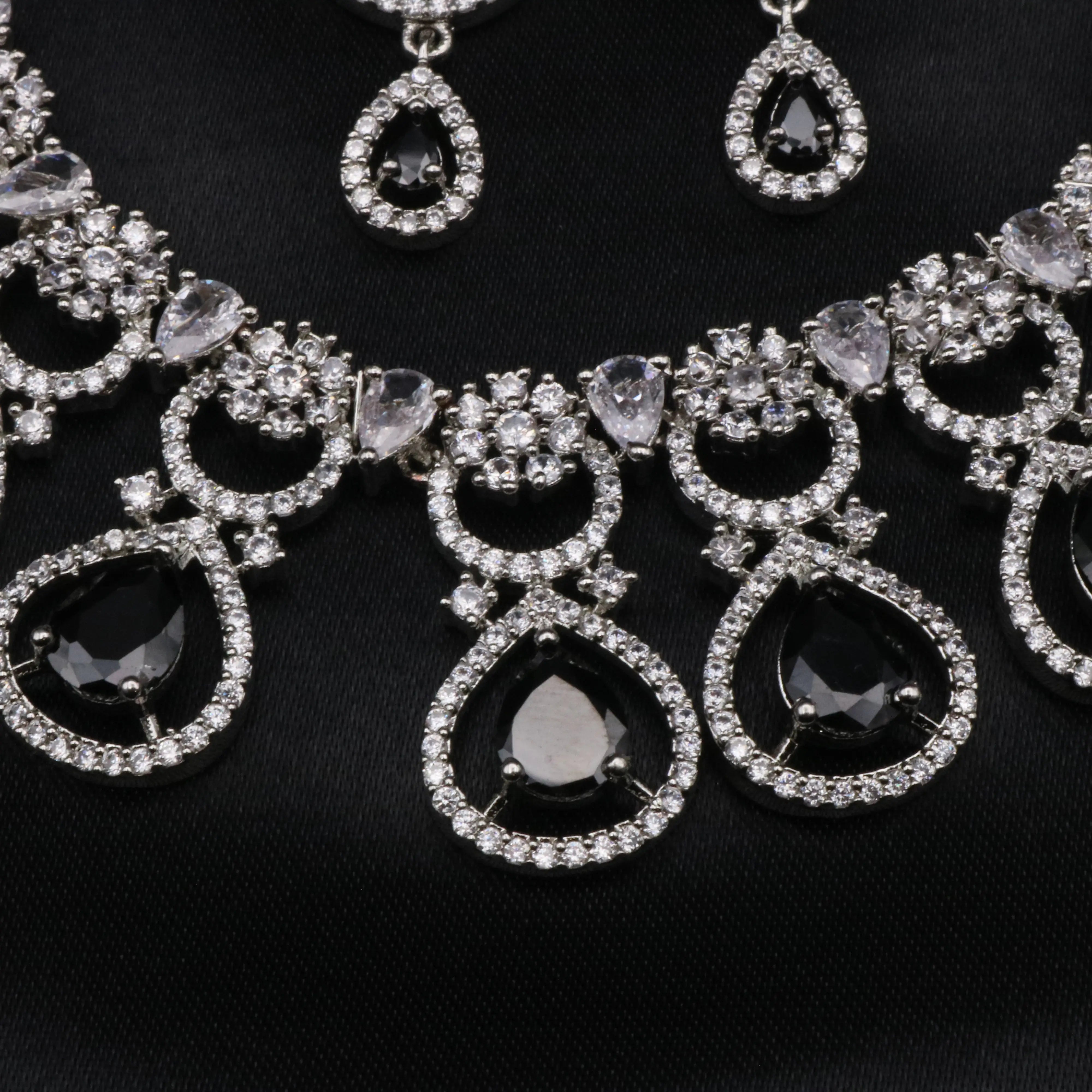 Close-up of black teardrop CZ stones surrounded by white CZ halos in the necklace.