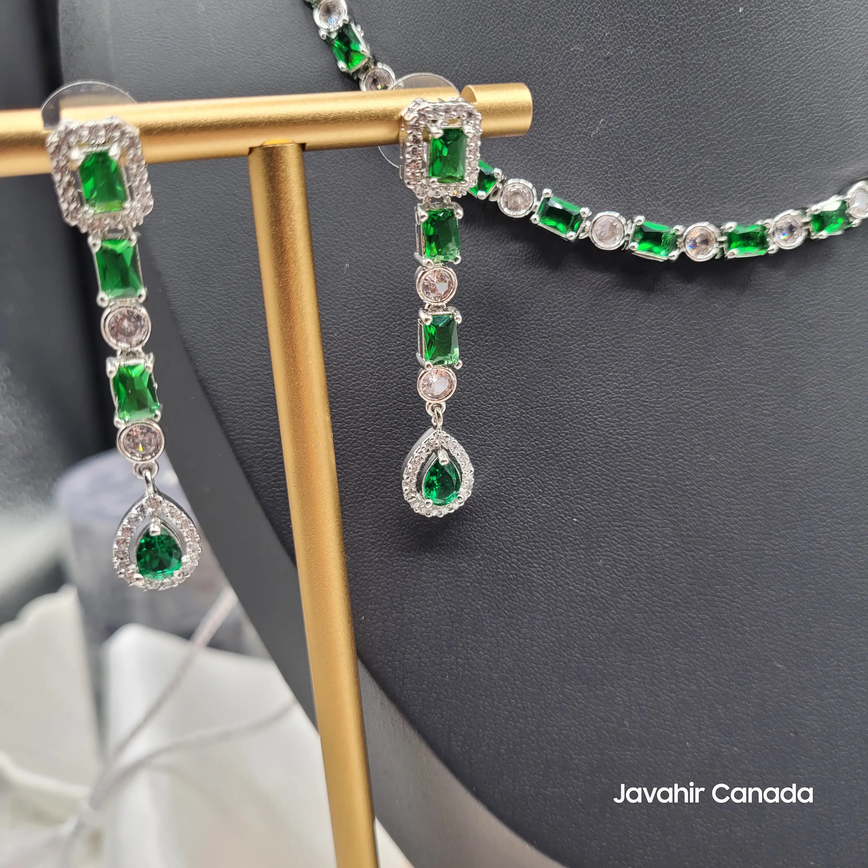 Full earring view of Luna set with rectangular green zircon stones and round CZ elements in a silver finish.