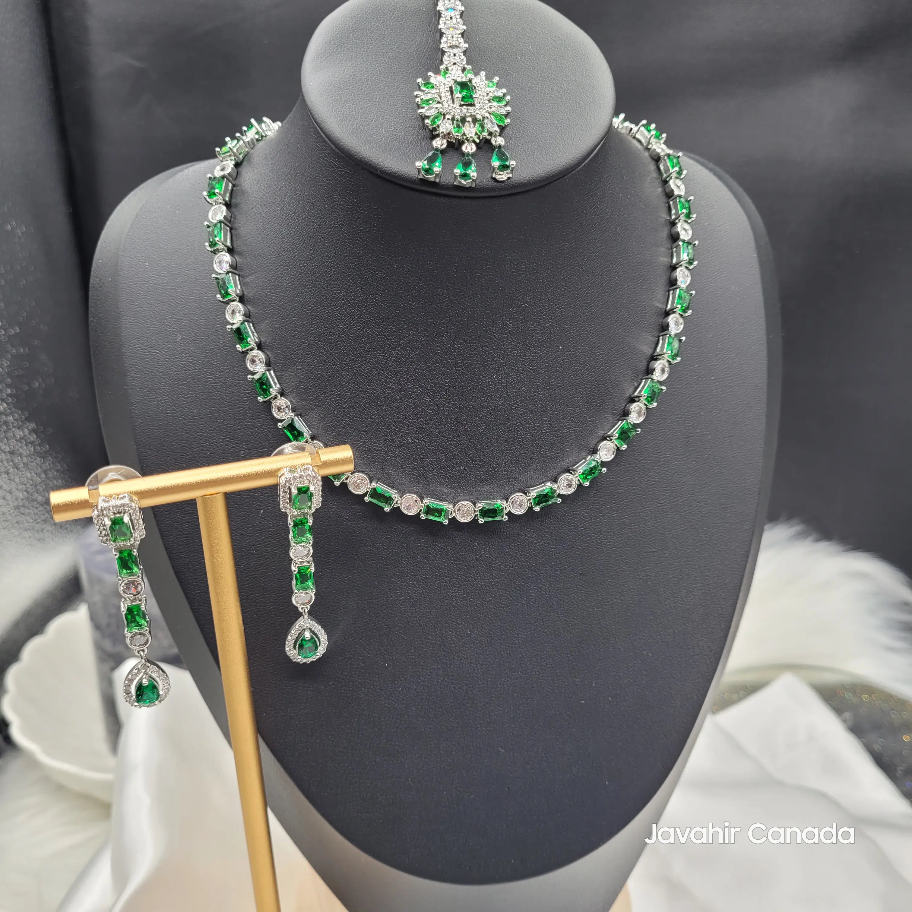 Luna necklace set displayed on bust stand showing complete matching tikka and earrings with green and silver detailing.