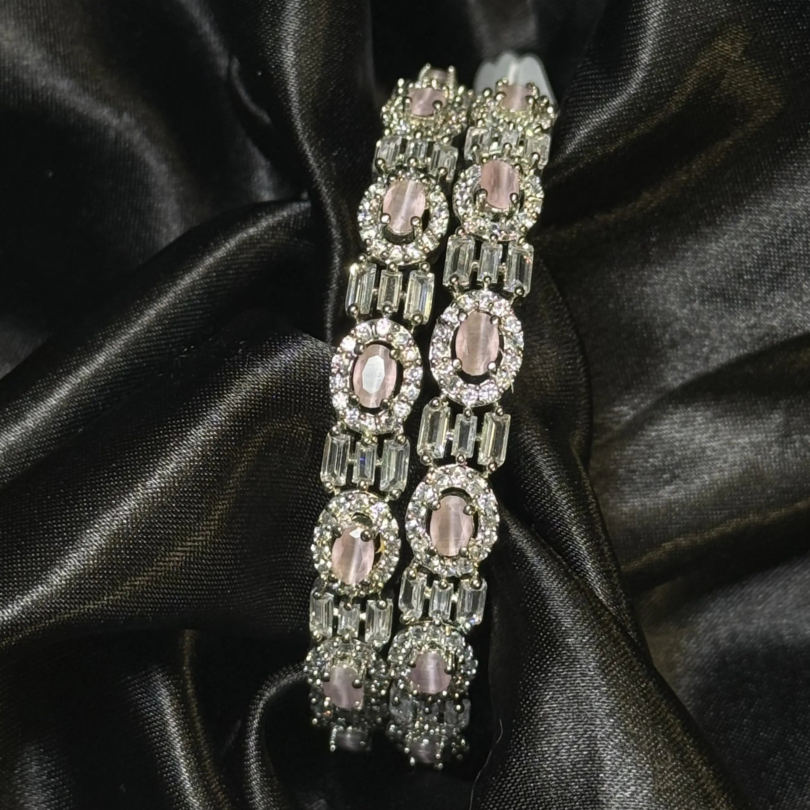 Silver bangles with pink oval stones and baguette crystal accents