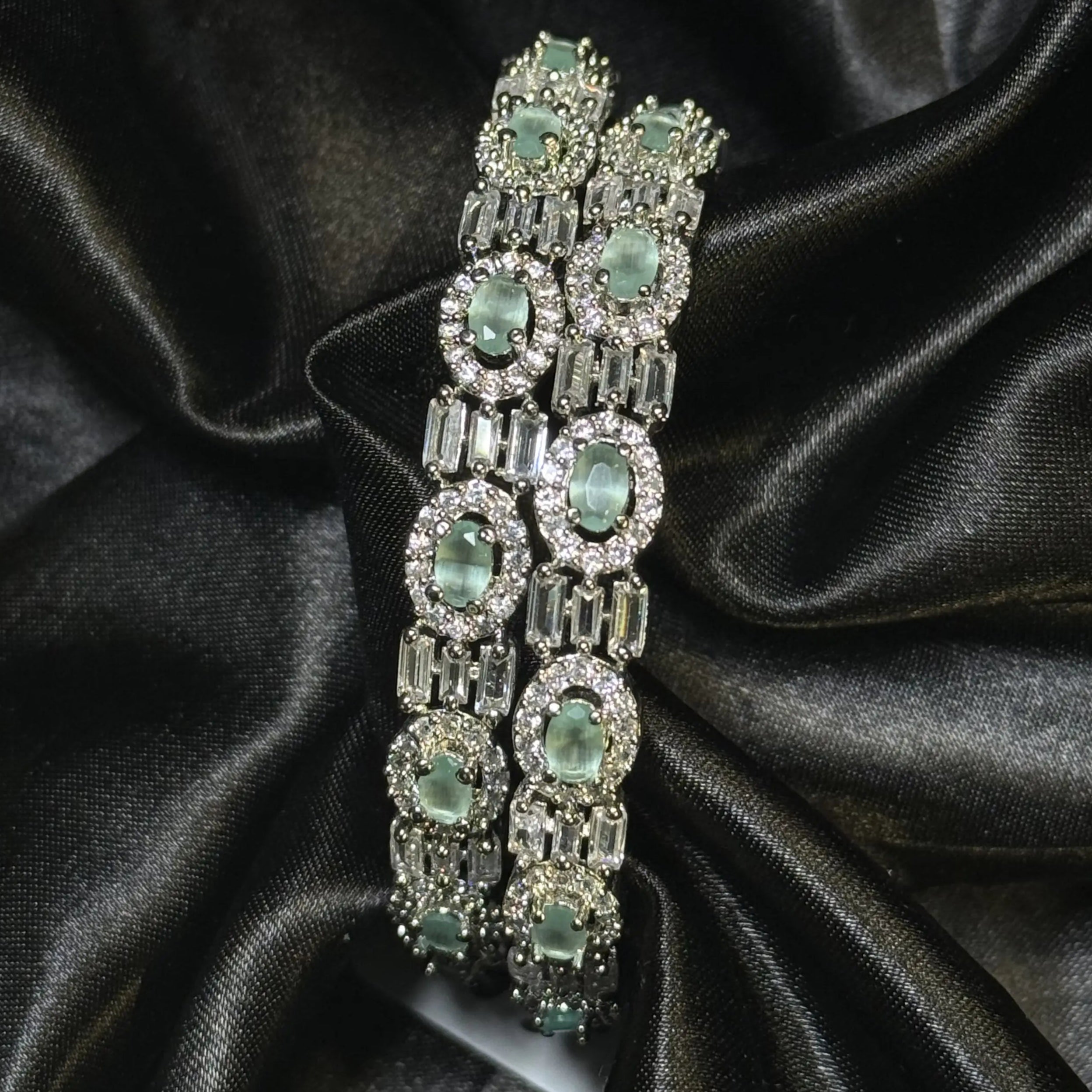 Set of 2 silver bangles with teal gemstones and zircon sparkle