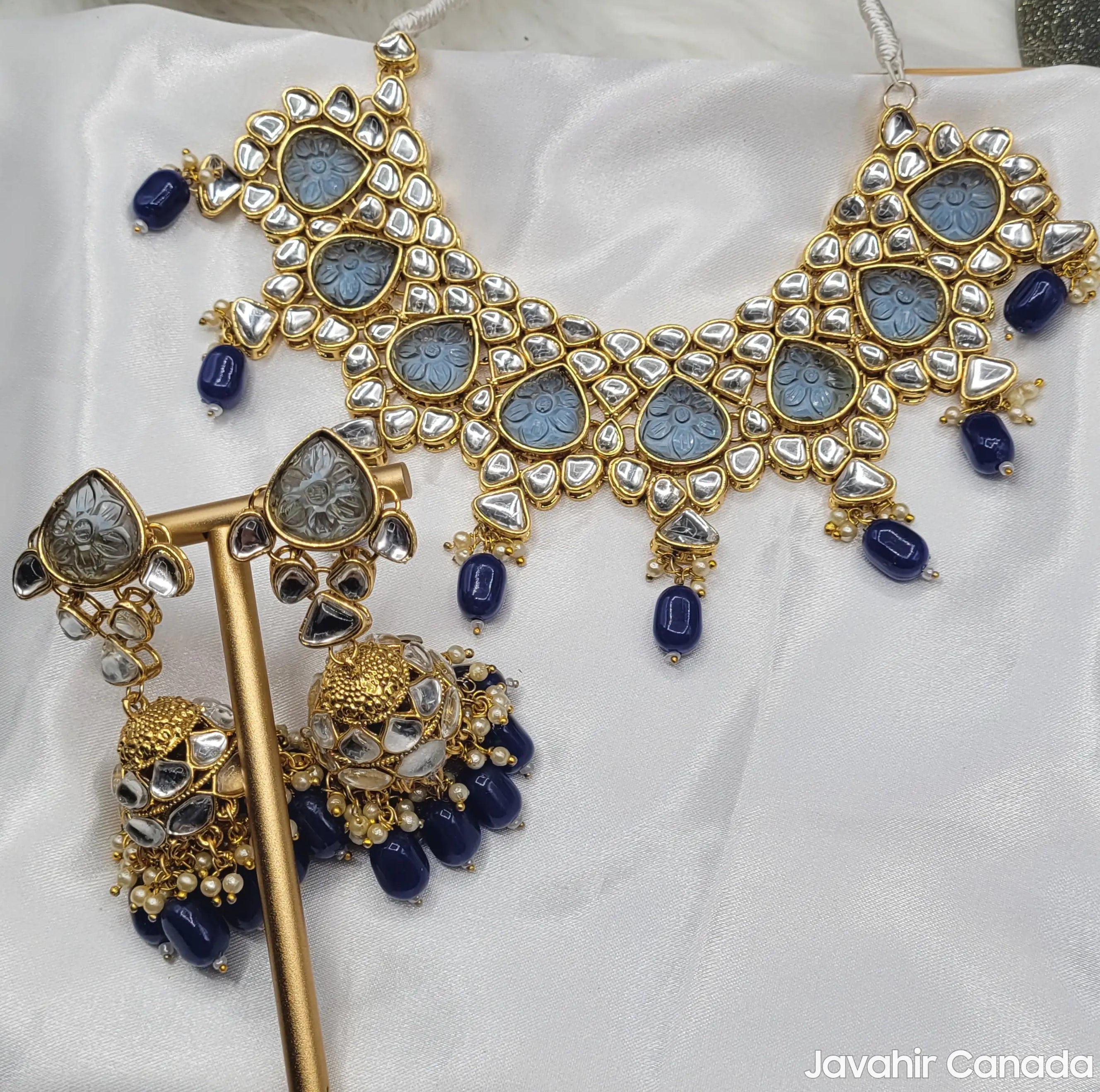 Full Marina necklace set displayed on white satin background showing both earrings and choker with detailed work.