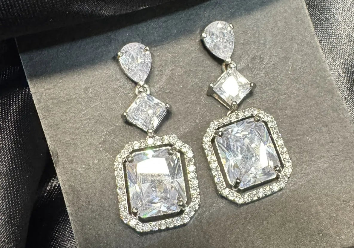 American diamond earrings on a black satin background