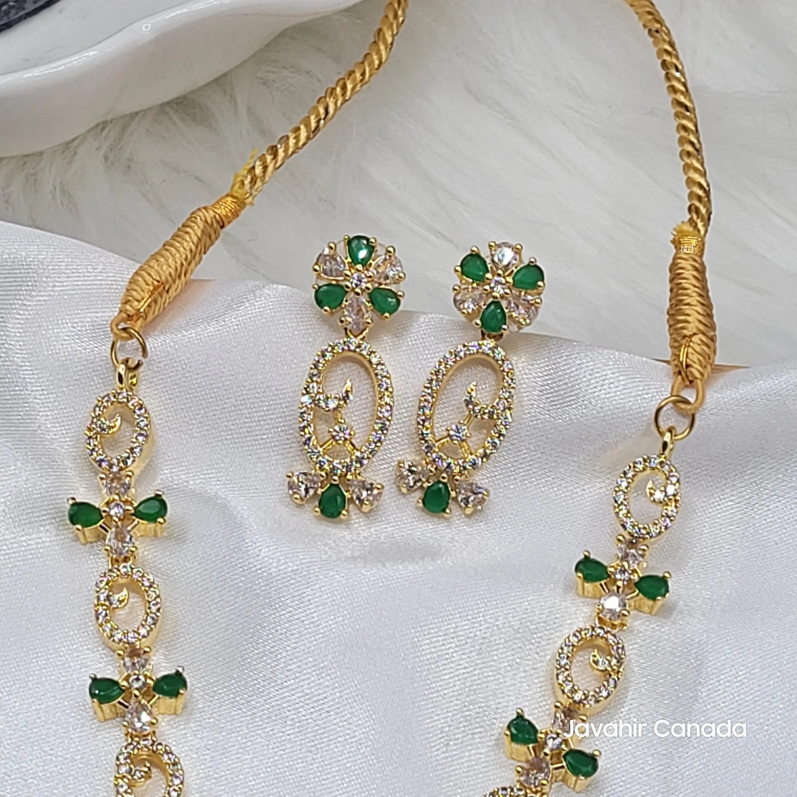 Earrings and upper necklace view showing sparkling CZ and delicate green accents from the Primrose set.