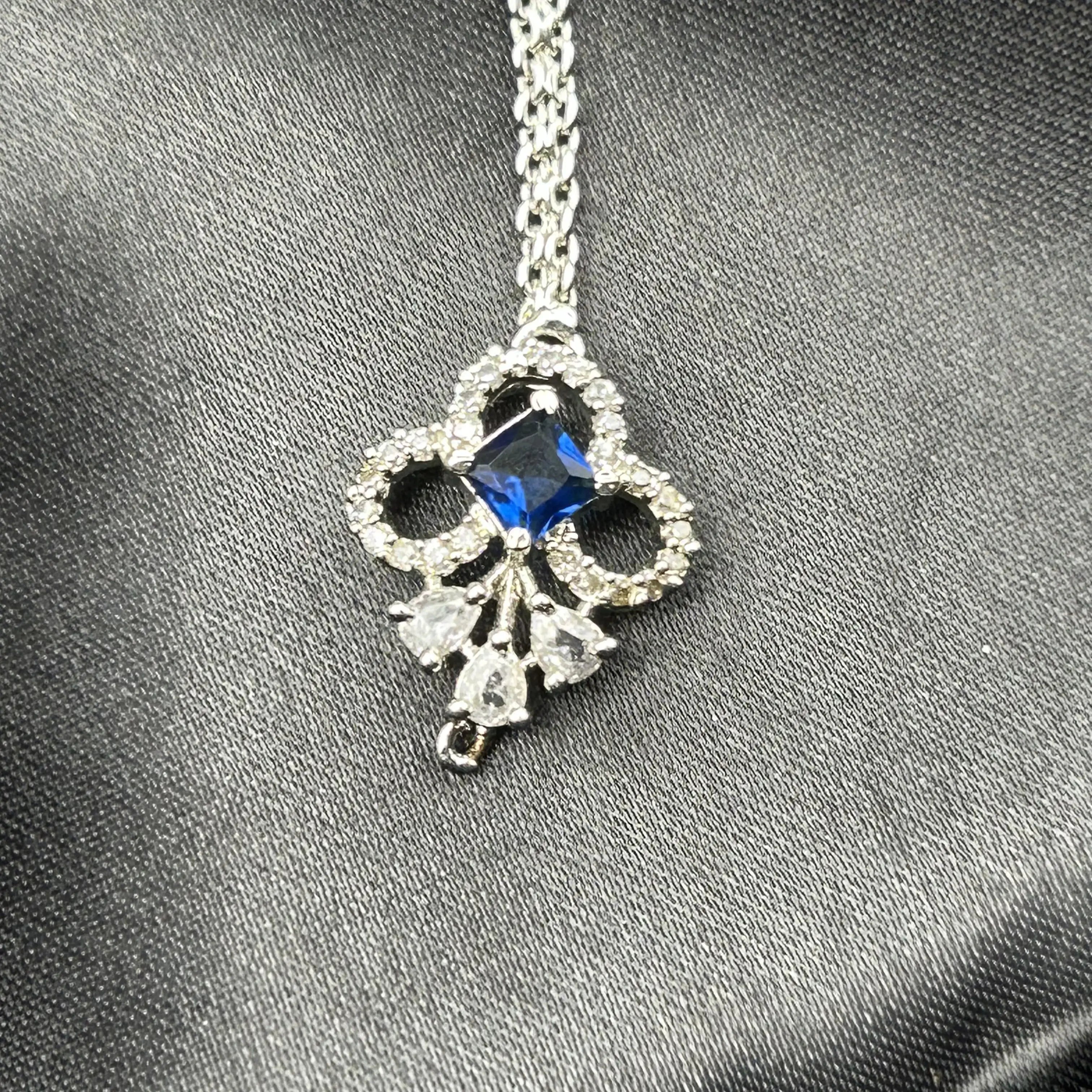 Close-up of American diamond and blue stone Maang Tikka