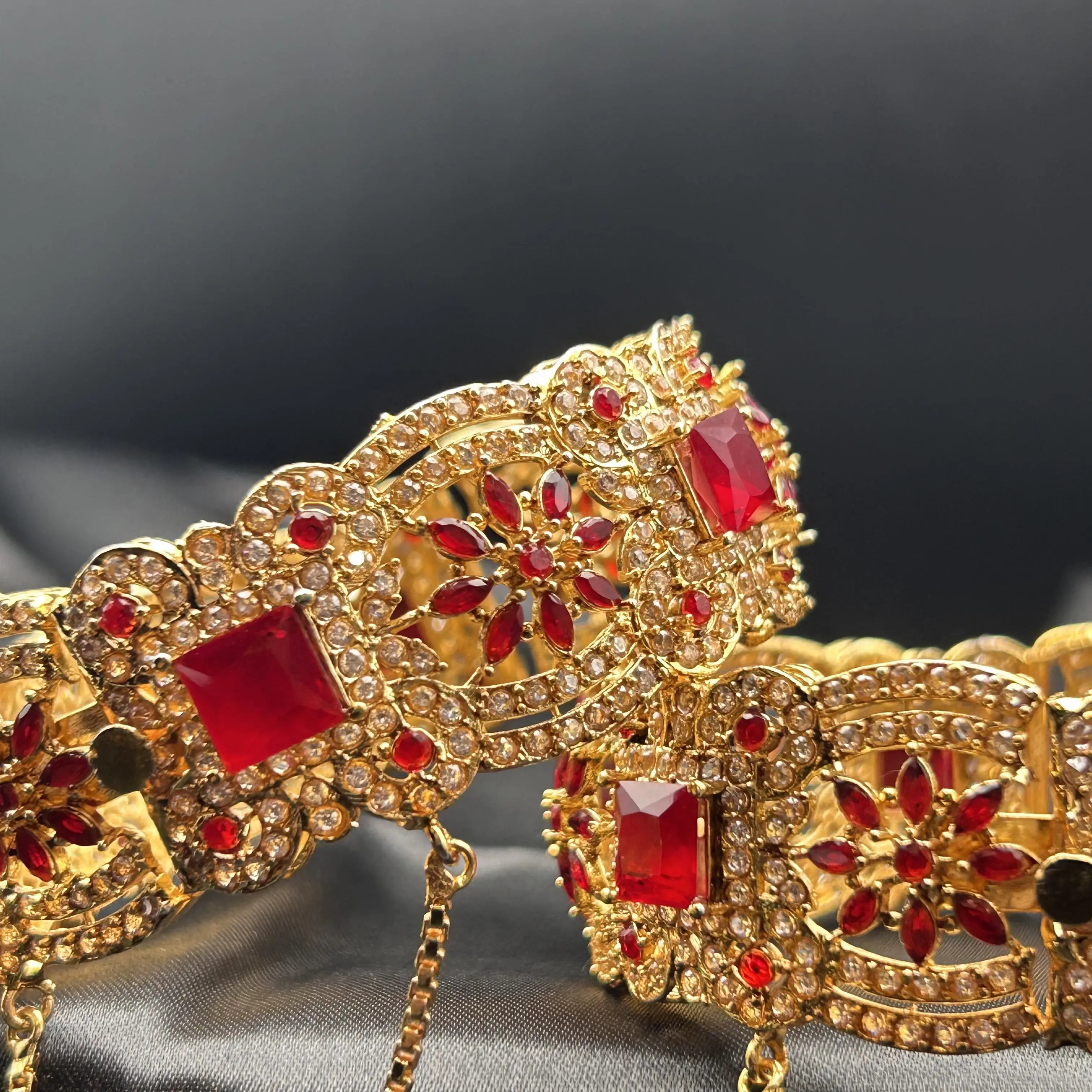 Openable gold-tone bangles with red marquise and crystal accents – side angle
