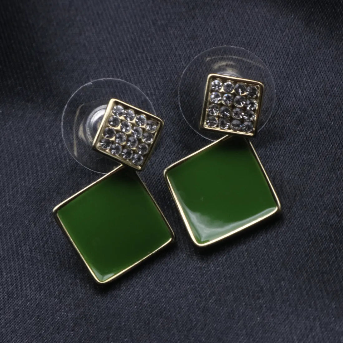 A pair of gold-plated sterling silver earrings with American diamond accents, featuring a green square design.