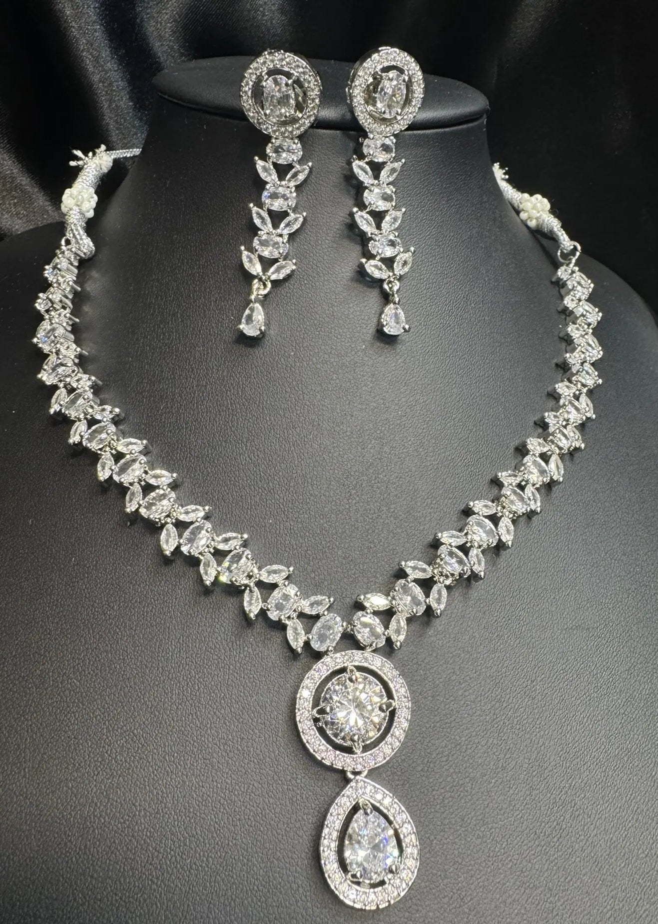 American Diamond necklace and earrings set on a black background