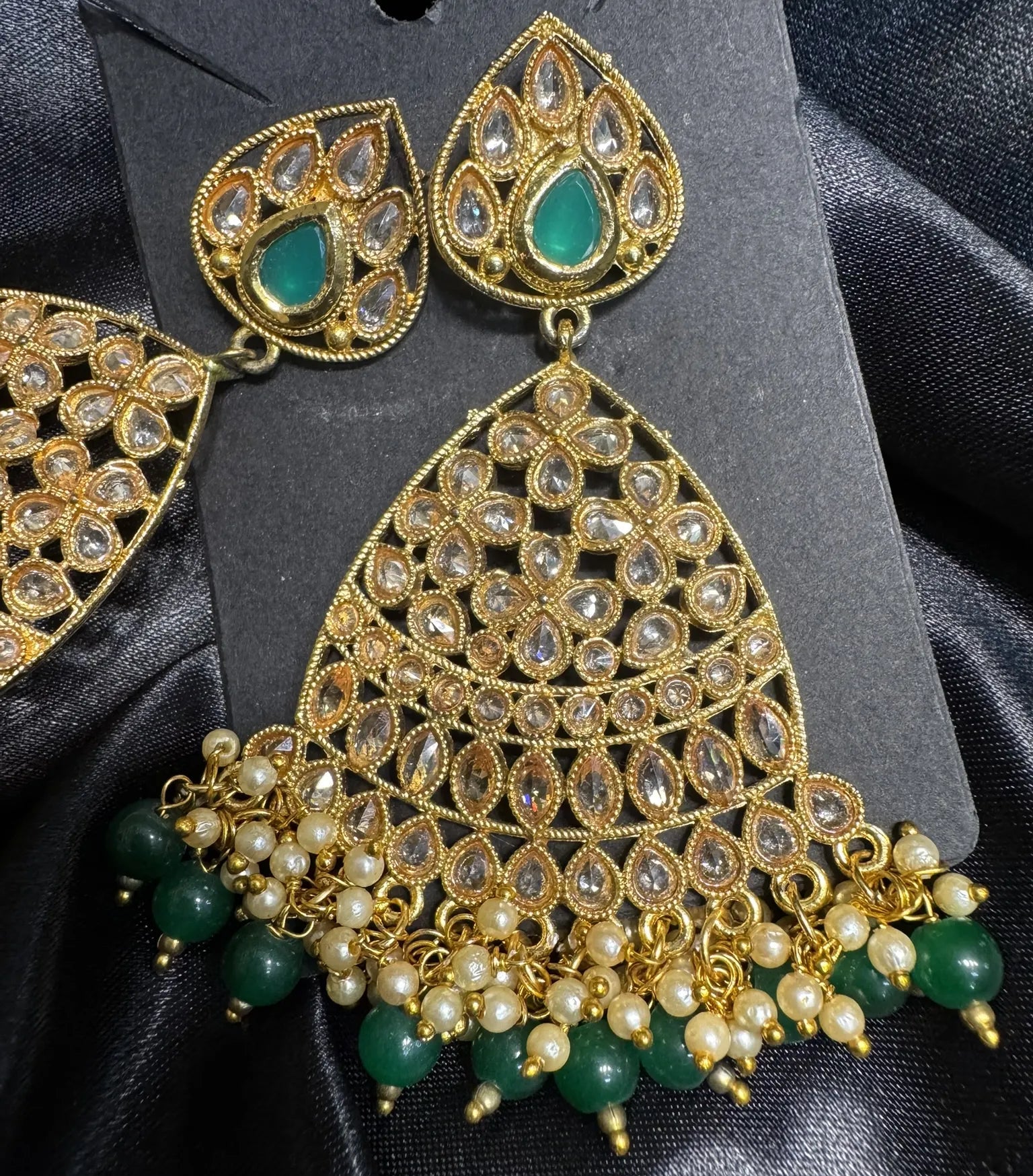 earrings with pearls as accent on a black background