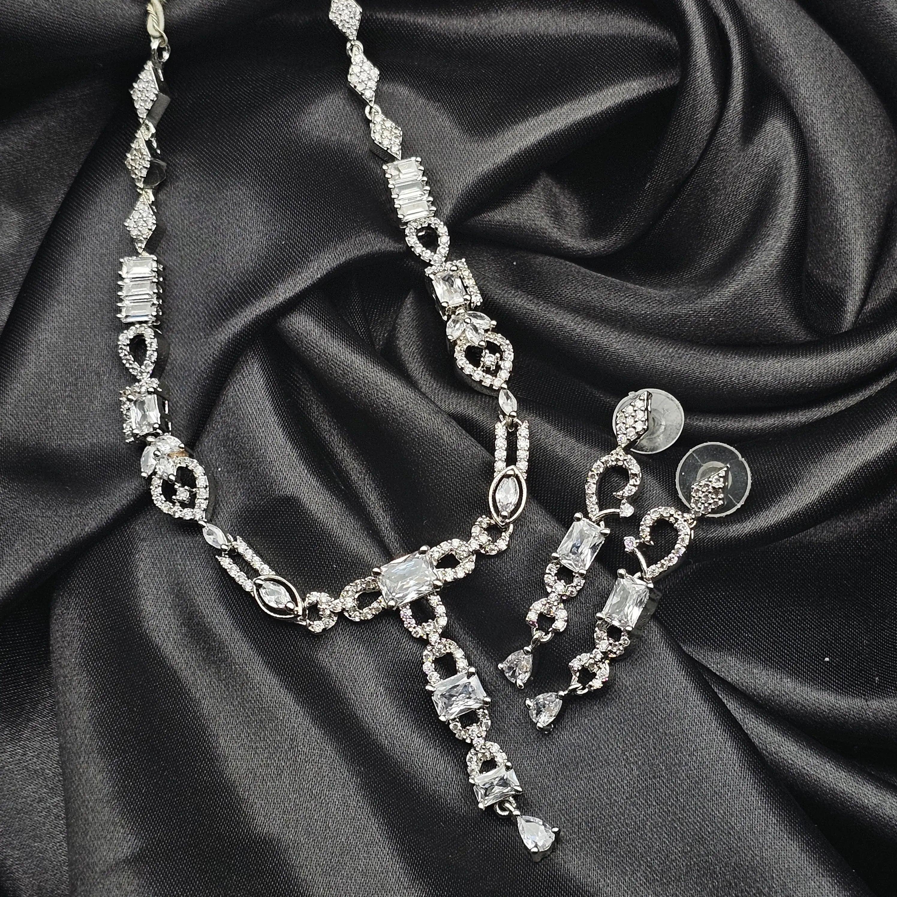 Twinning Vine AD Necklace Set displayed on black fabric, featuring silver links and CZ stones