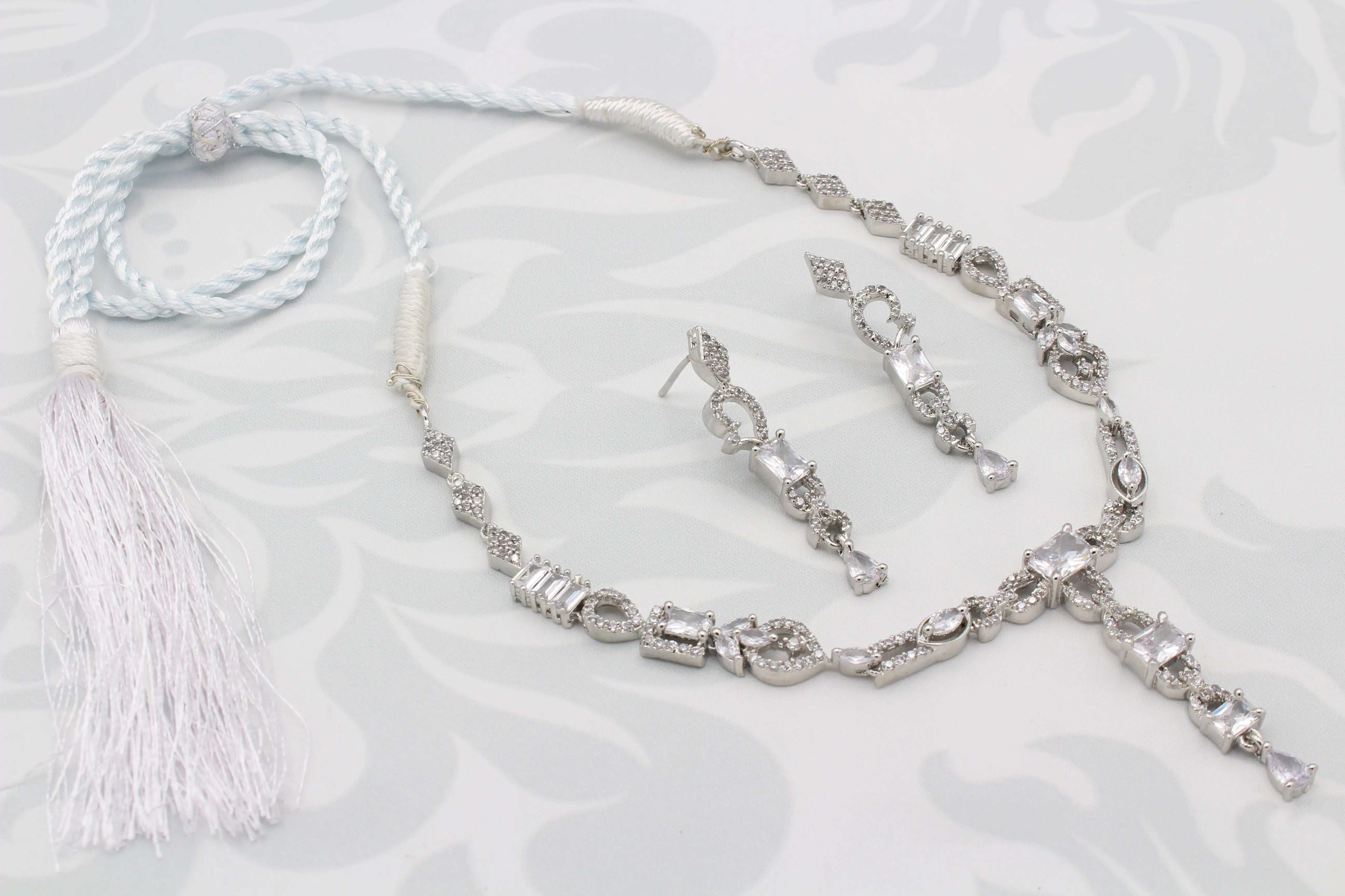 Complete view of the Twinning Vine Necklace Set with tassel tie, earrings, and detailed craftsmanship
