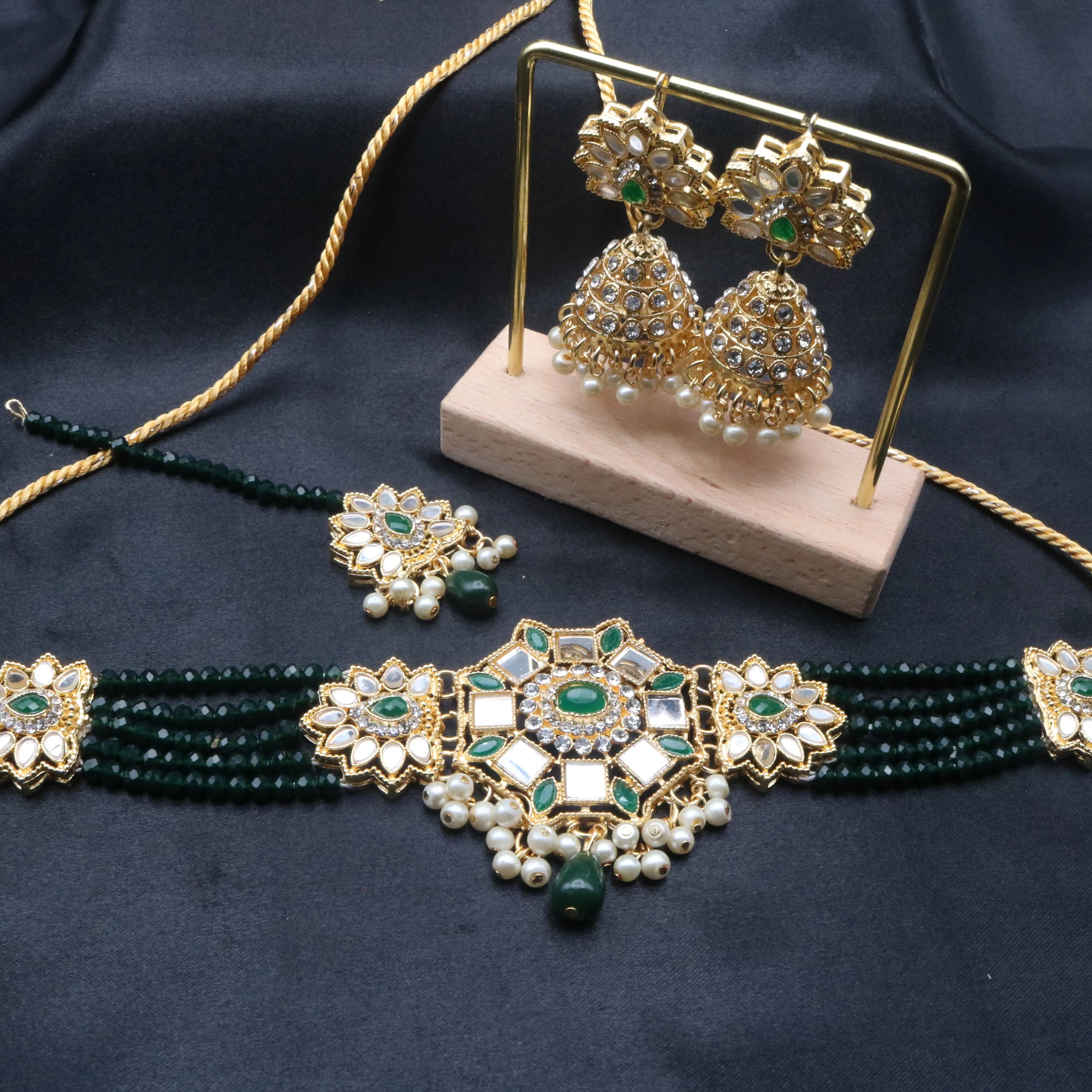 Zinnia kundan necklace set with green beads and jhumka earrings on display