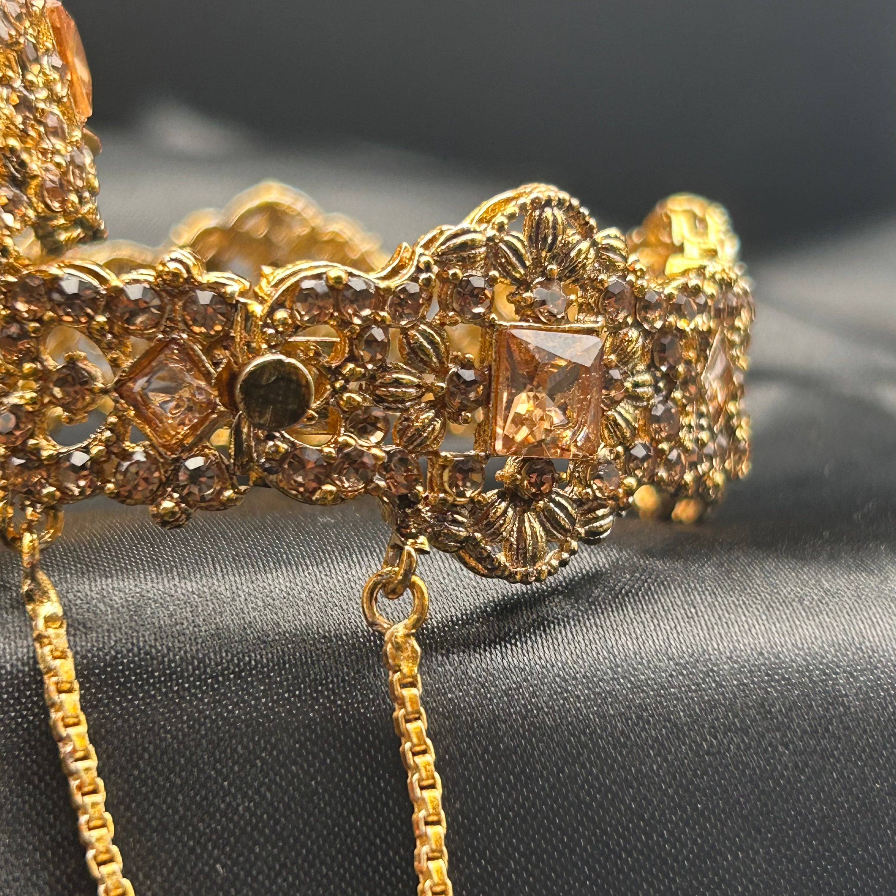 Angled view showing full design and chain clasp on Ancient bangles