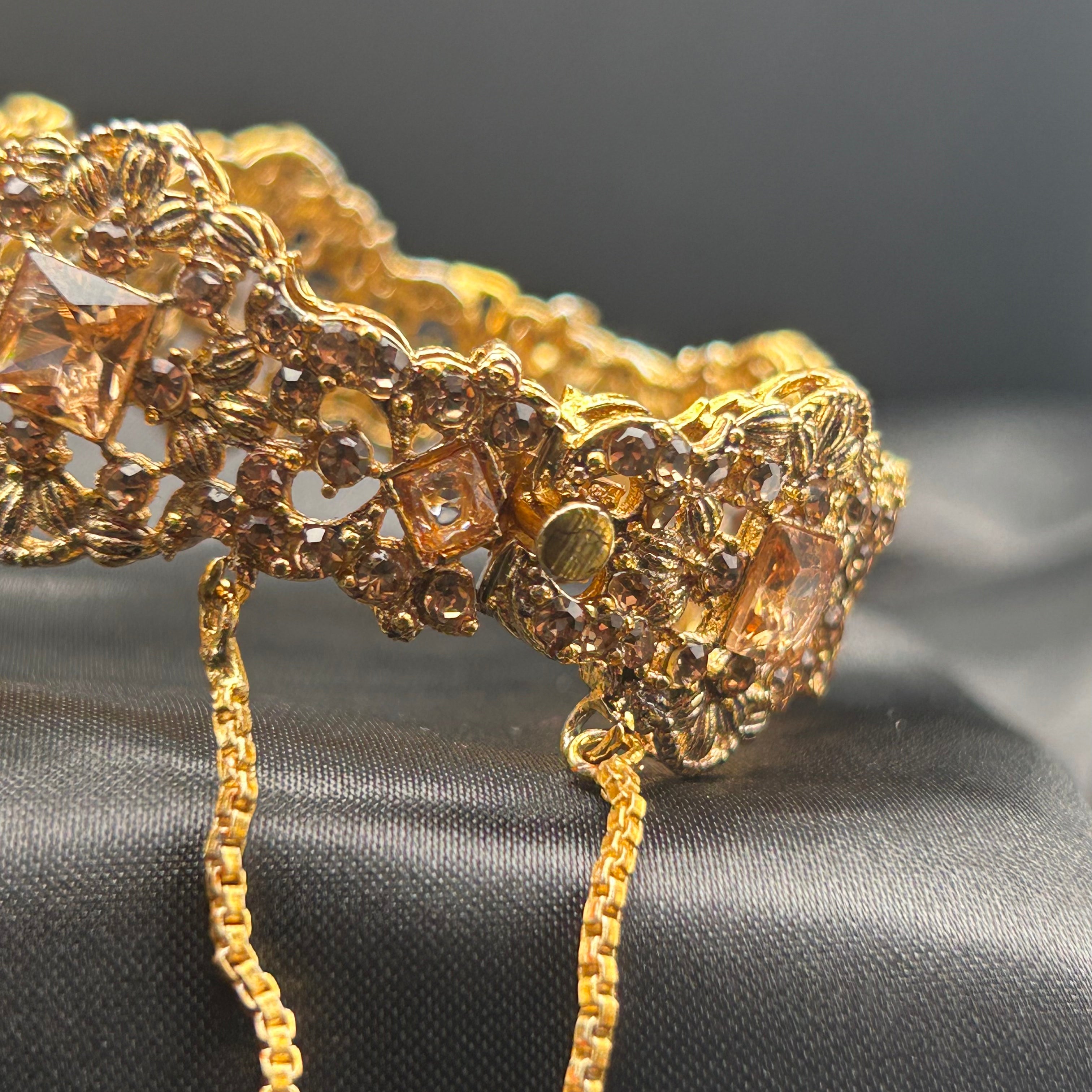 another angled view showing full design and chain clasp on Ancient bangles