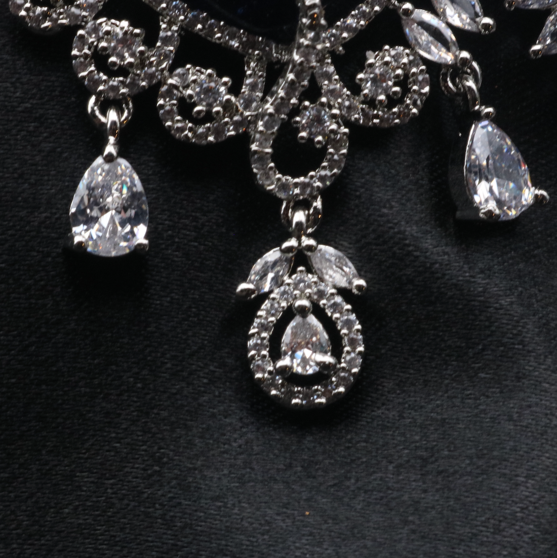 bottom view of pair of silver American diamond earrings with clear gemstones. Stainless steel and waterproof.