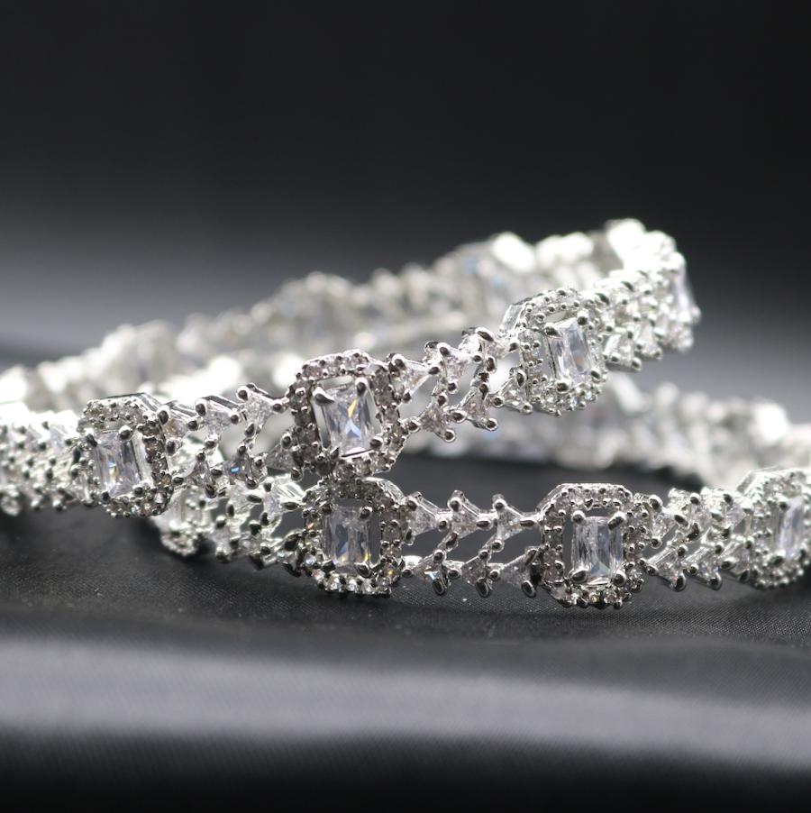 A pair of stainless steel bangles adorned with sparkling American diamonds.