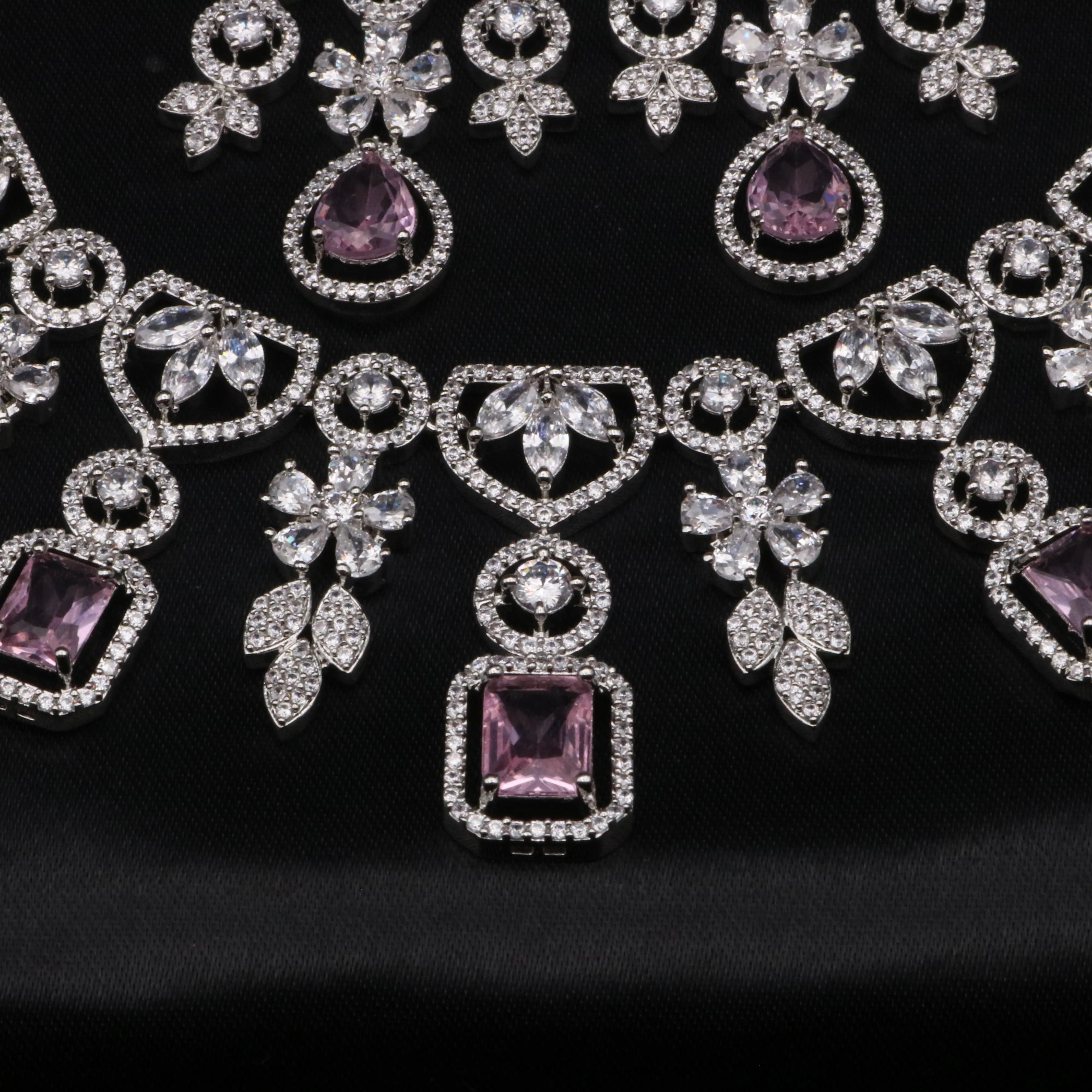 Close-up of lavender square-cut CZ centerpiece surrounded by detailed American diamond floral accents.