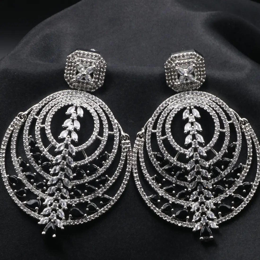 American diamonds earrings with black gemstones on a black background