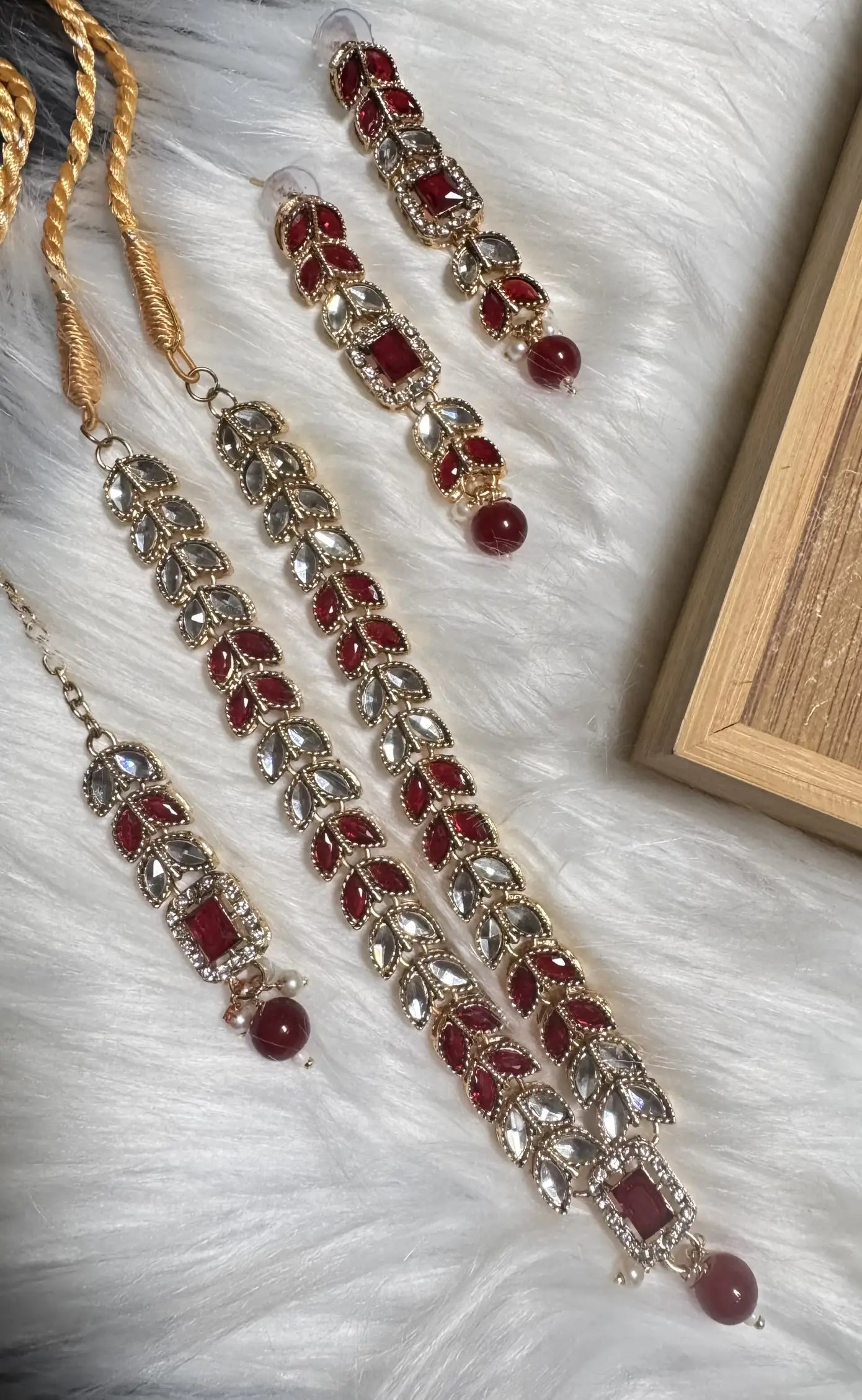 Top view of Bloom ruby red set with rectangular stone pendants and matching earrings.
