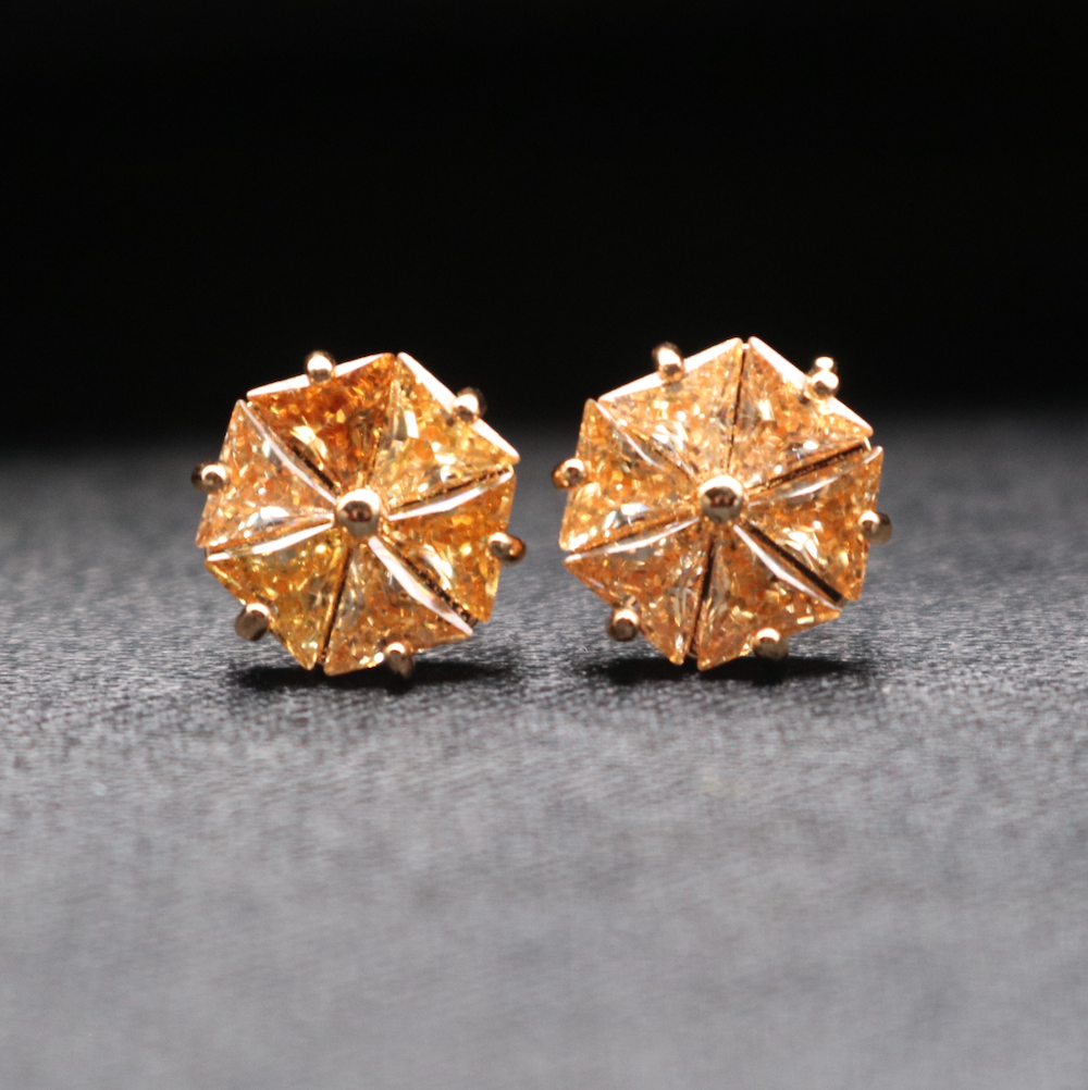 A pair of stud earrings featuring gold gemstones set in gold-plated sterling silver.