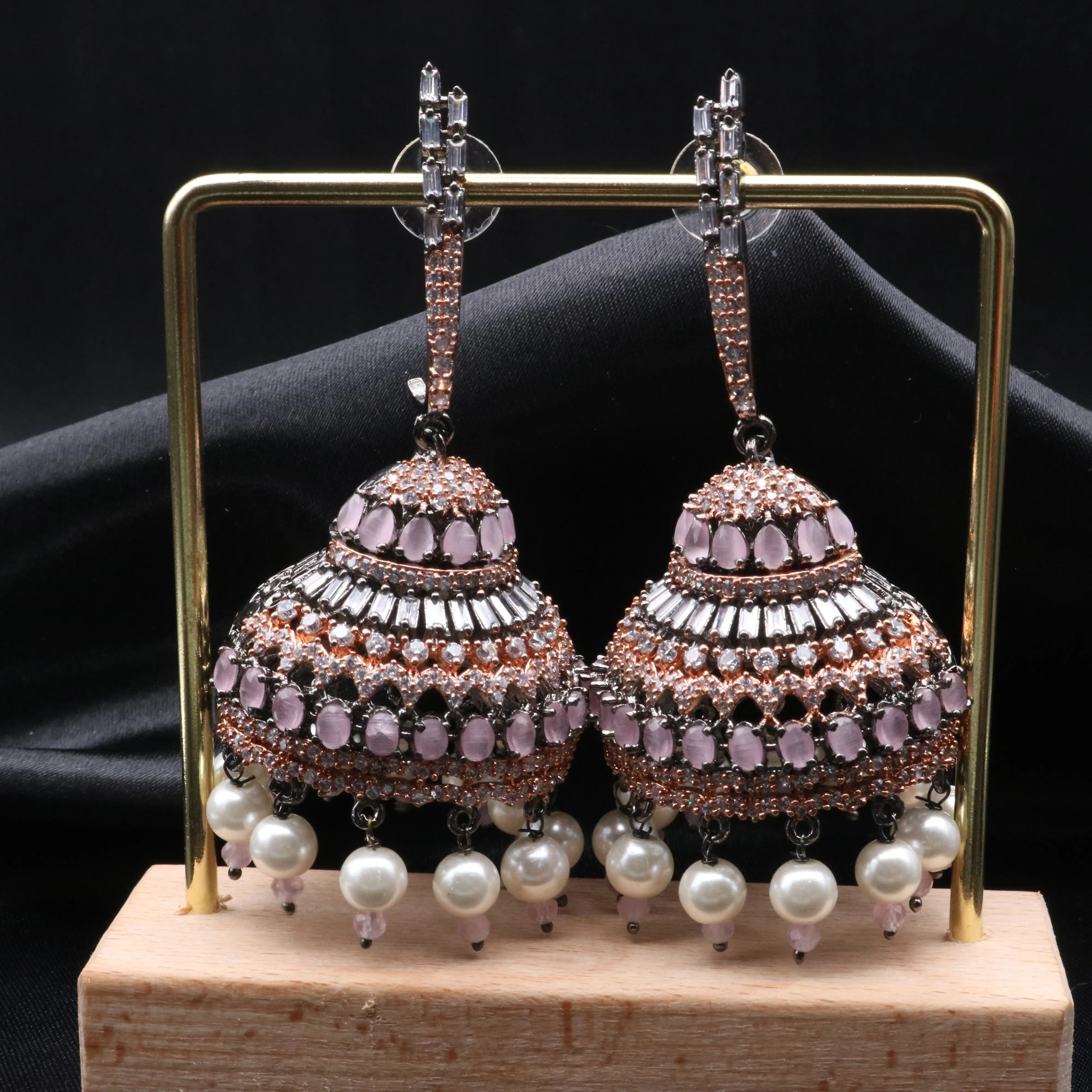 Pakistani design jhumkay with jarao craftsmanship. Antique polish with pink gemstones and pearl accents providing an exquisite touch.