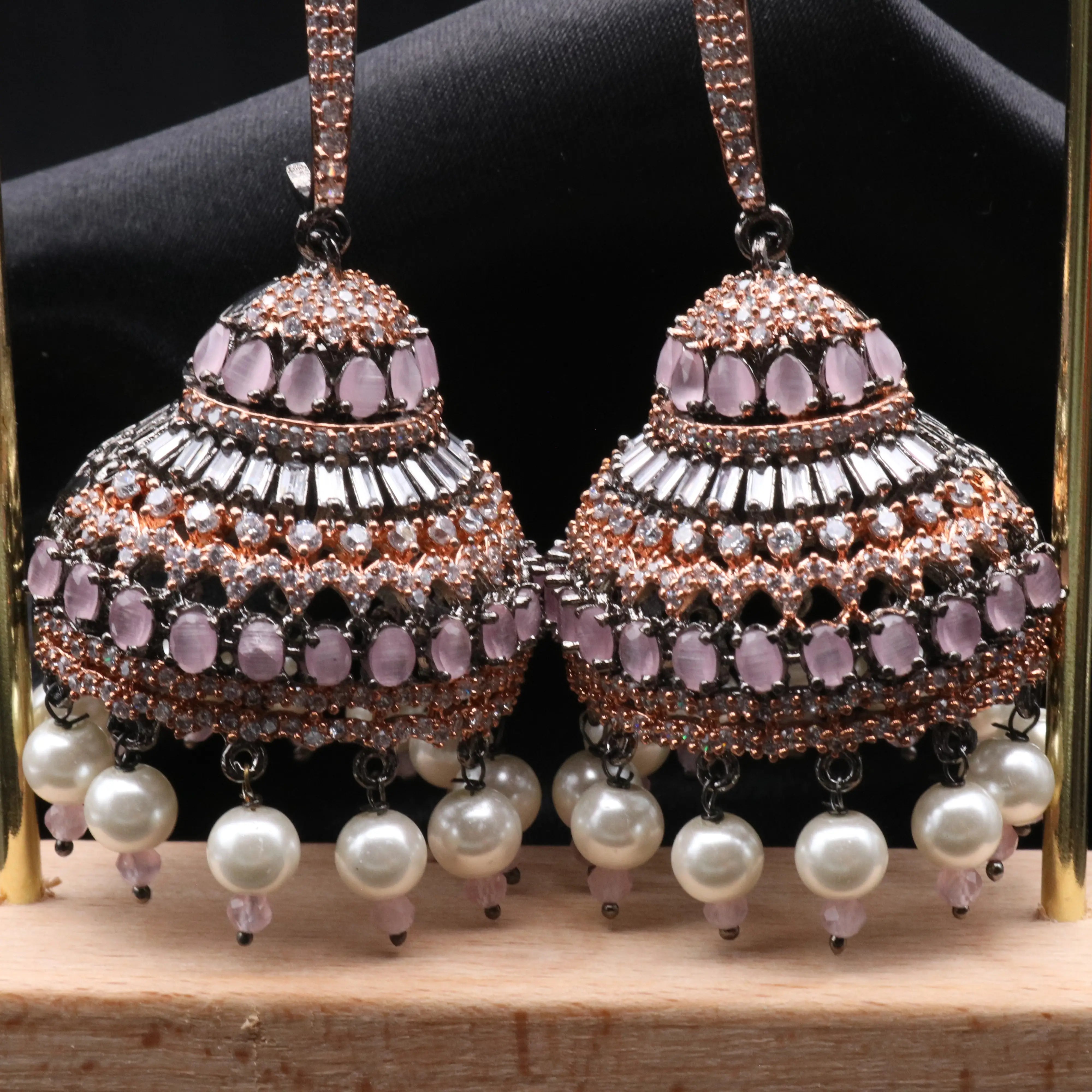 bottom part of Pakistani design jhumkay with jarao craftsmanship. Antique polish with pink gemstones and pearl accents providing an exquisite touch.