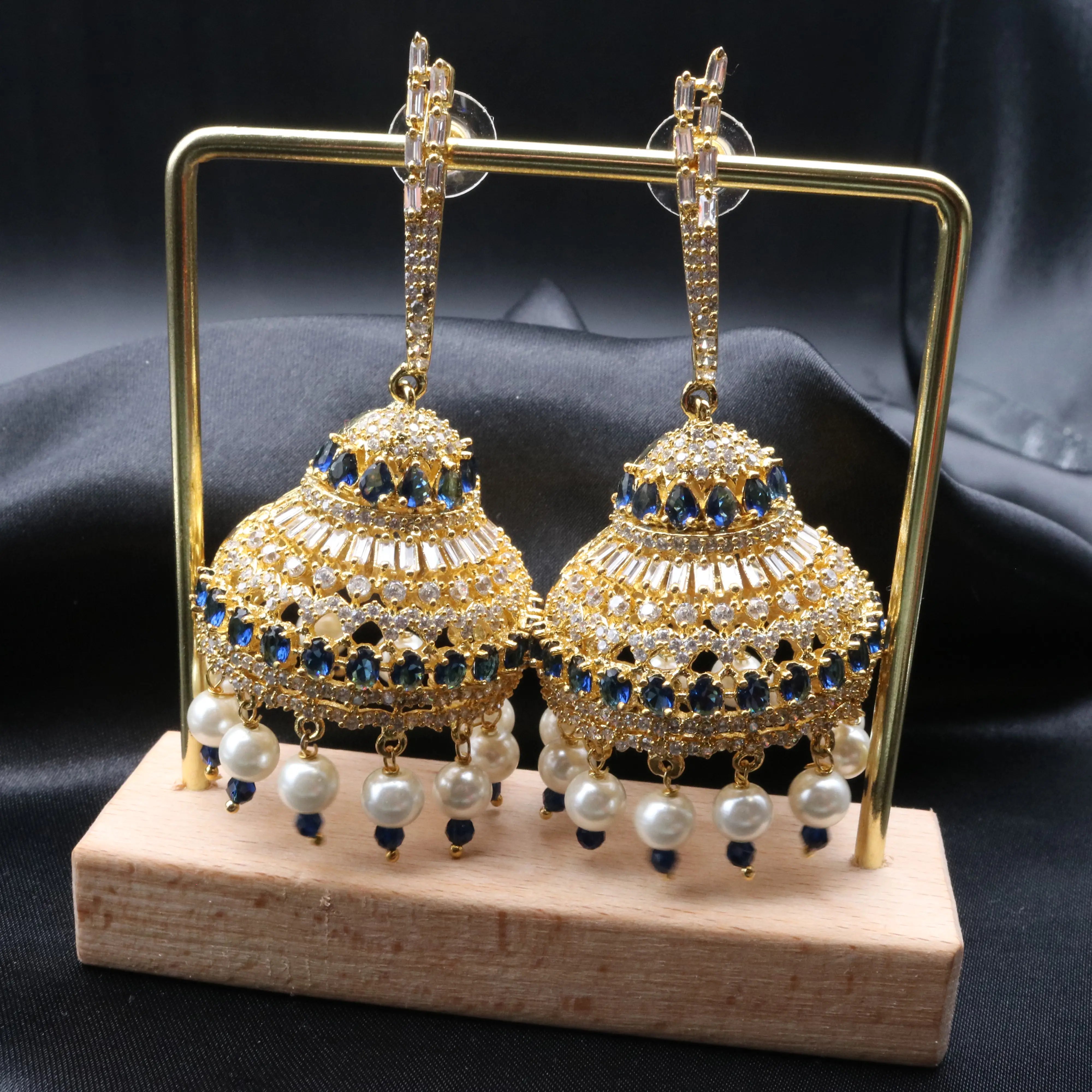 Pakistani design jhumkay with jarao craftsmanship. Blue and clear gemstones with pearl accents providing an exquisite touch.