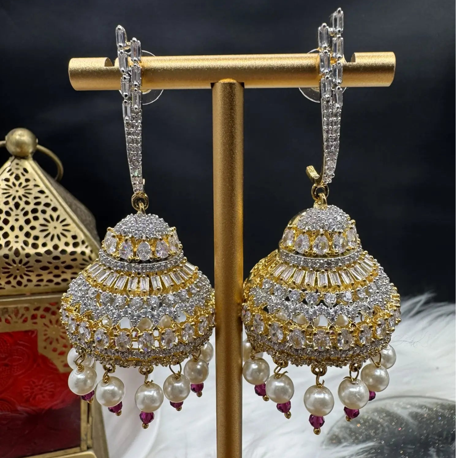 Pakistani design jhumkay with jarao craftsmanship. Clear gemstones with pearl accents providing an exquisite touch.